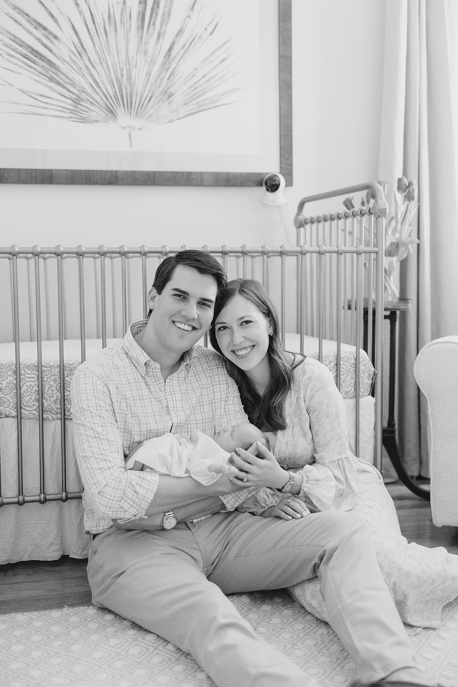 black and white photo of parents with baby girl