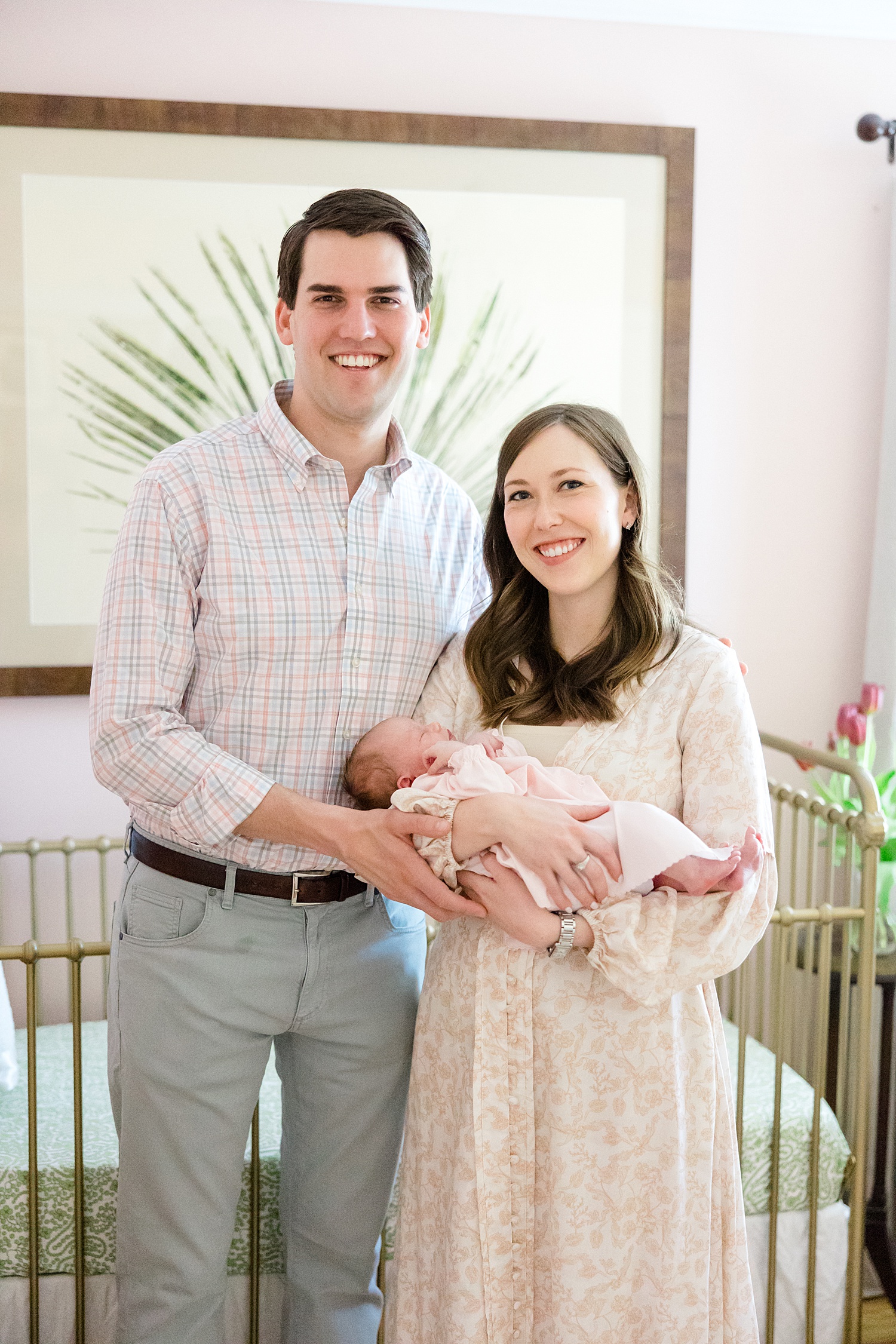 new parents hold baby girl
