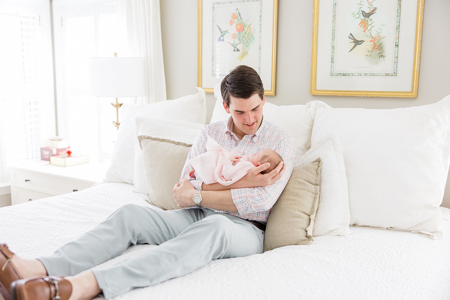 dad holds daughter during newborn session in-home