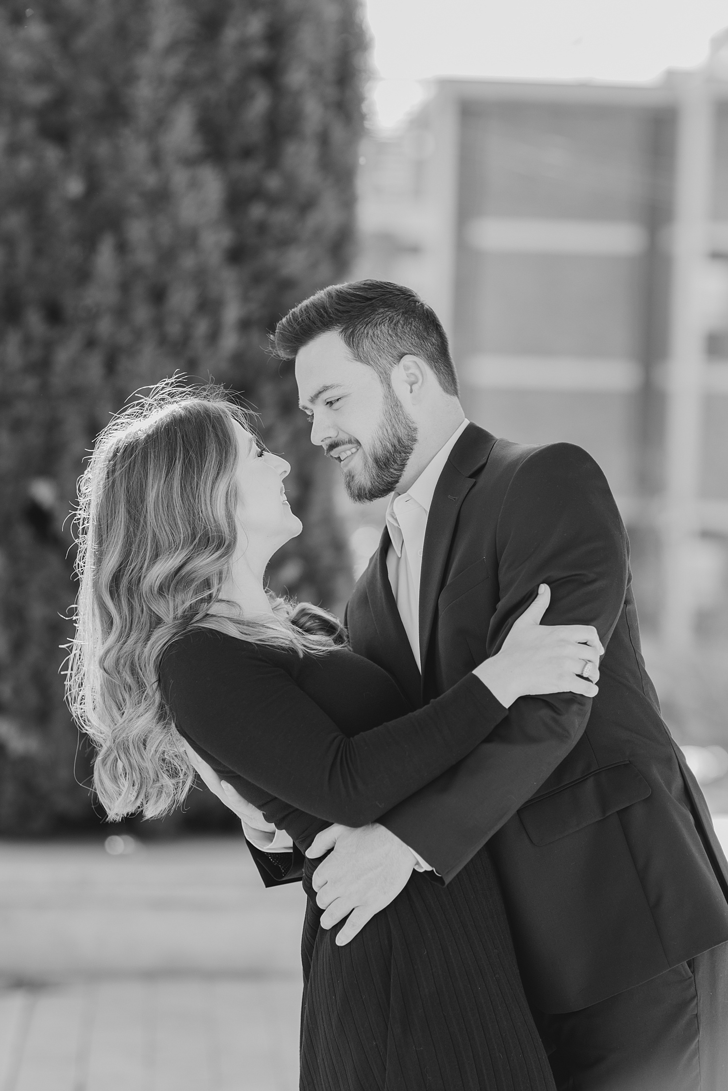 man dips his fiance during engagement portraits