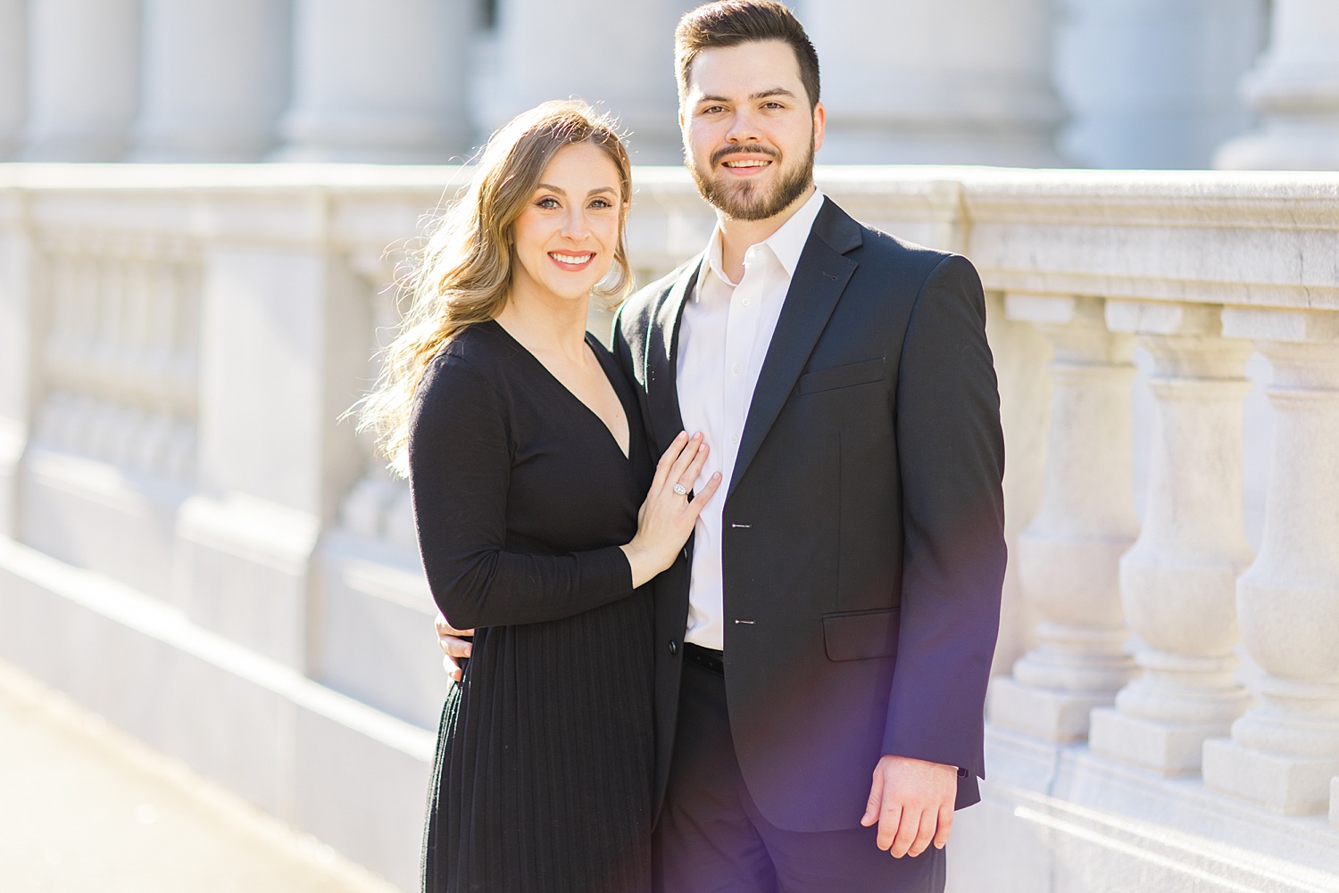 couple stand outside federal courthouse during classic engagement portraits