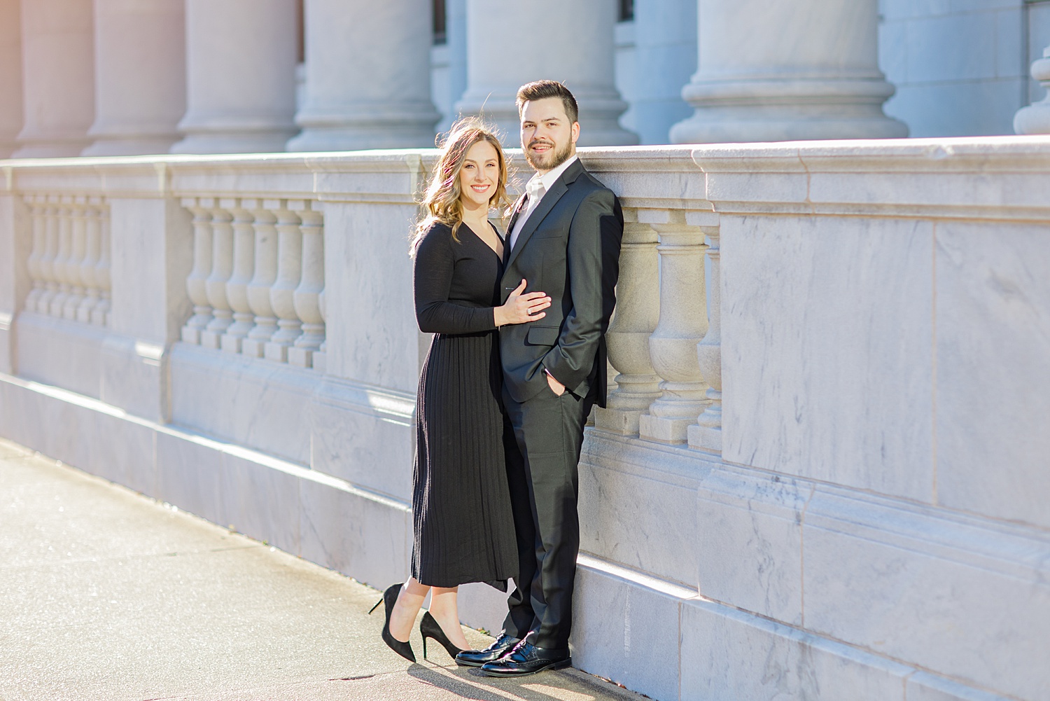 newly engaged couple lean against building in downtown AL