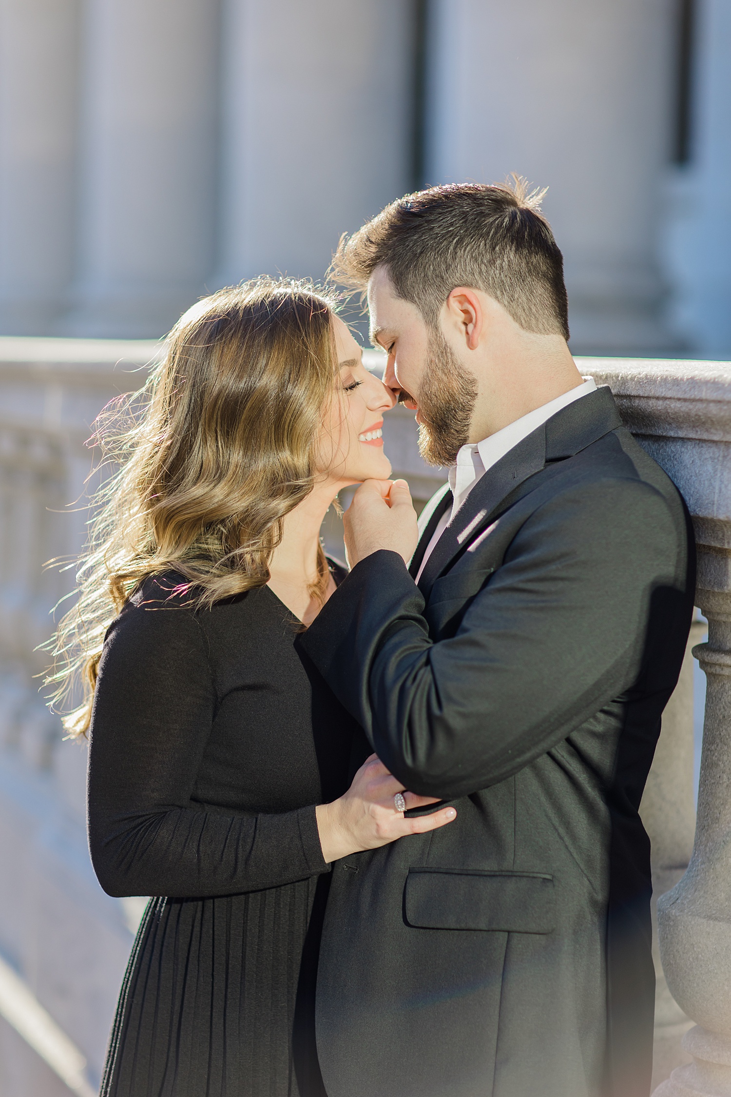 couple lean in to kiss during engagement session