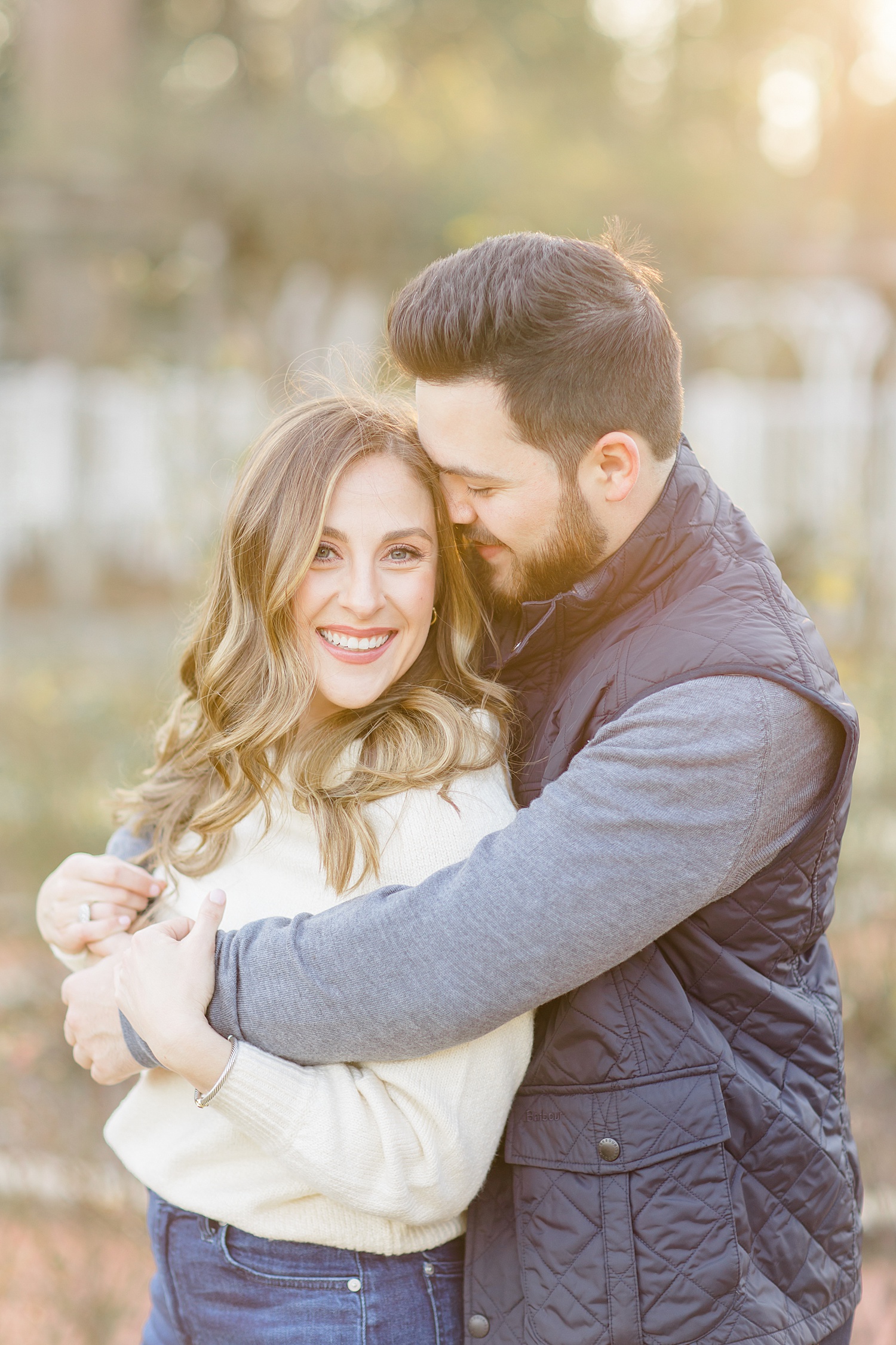 man hugs fiance during classic engagement portraits