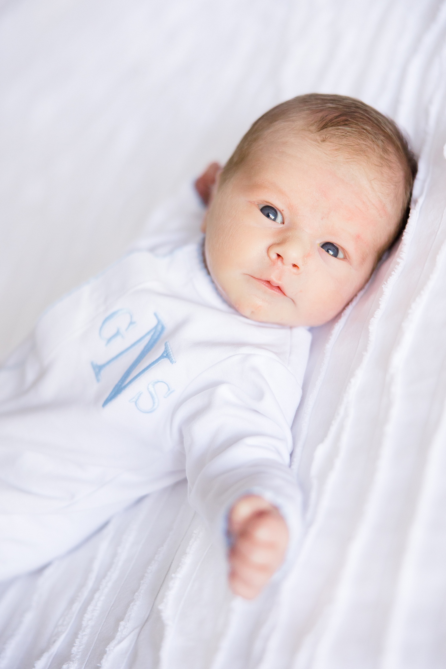 newborn boy lies awake during in-home newborn session