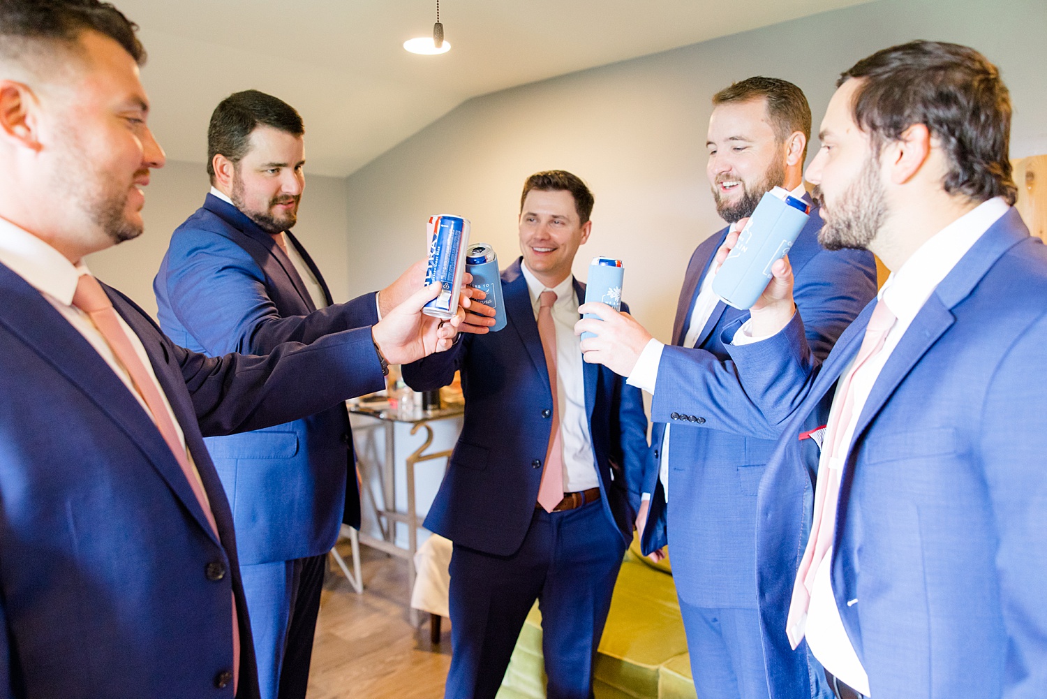 groom and groomsmen toast to wedding day