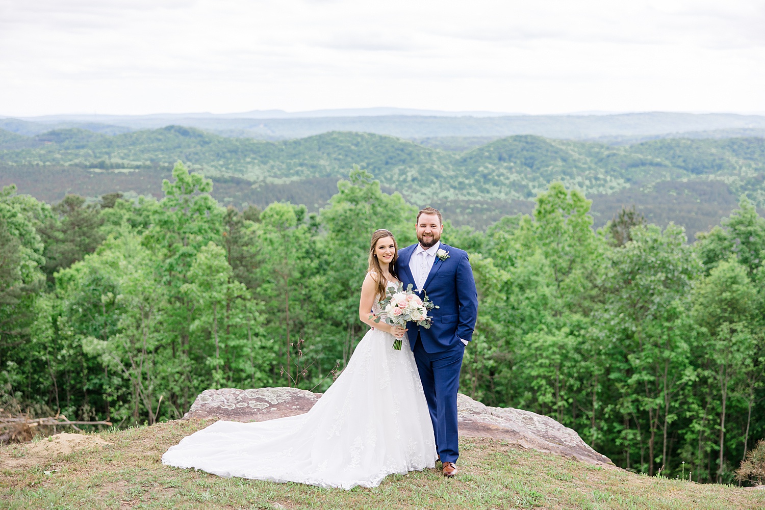 wedding portraits on top of hill overlooking rolling hills and valleys below 