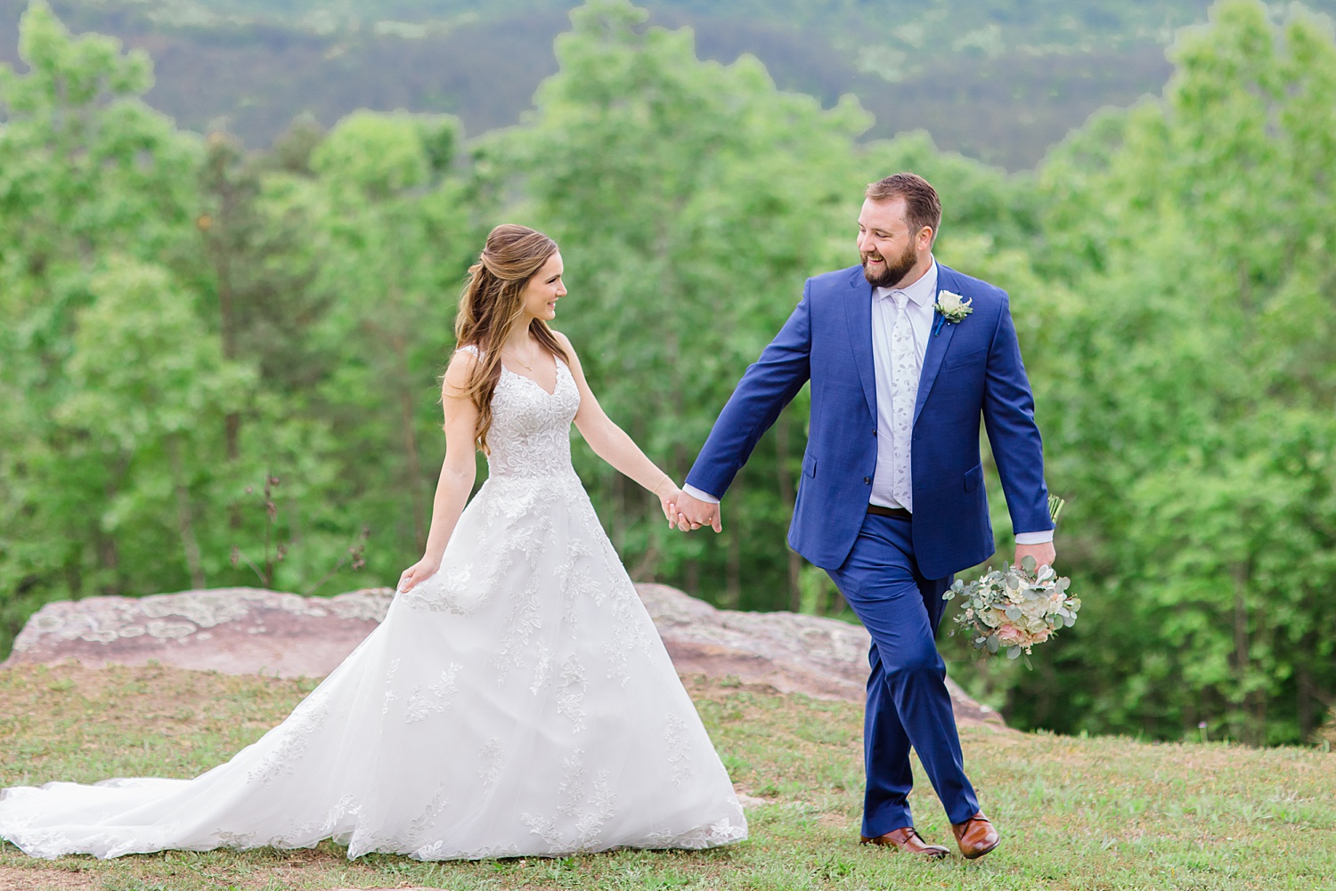 man leads his bride as they walk together 