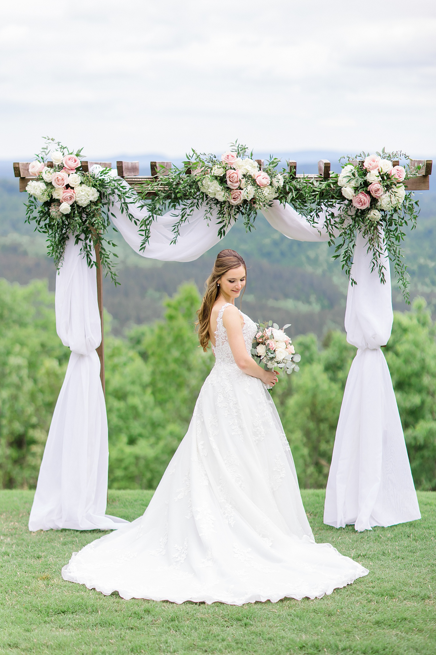 gorgeous classic wedding flowers decorate wedding arch 