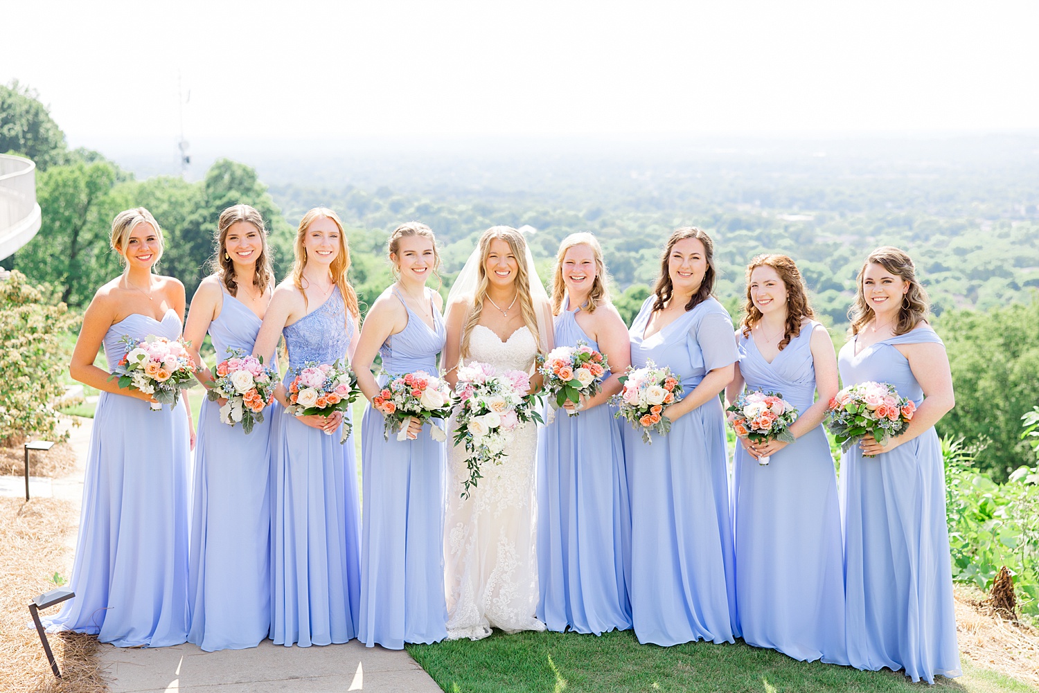bride and bridesmaids on hilltop in Birmingham after romantic and classic wedding