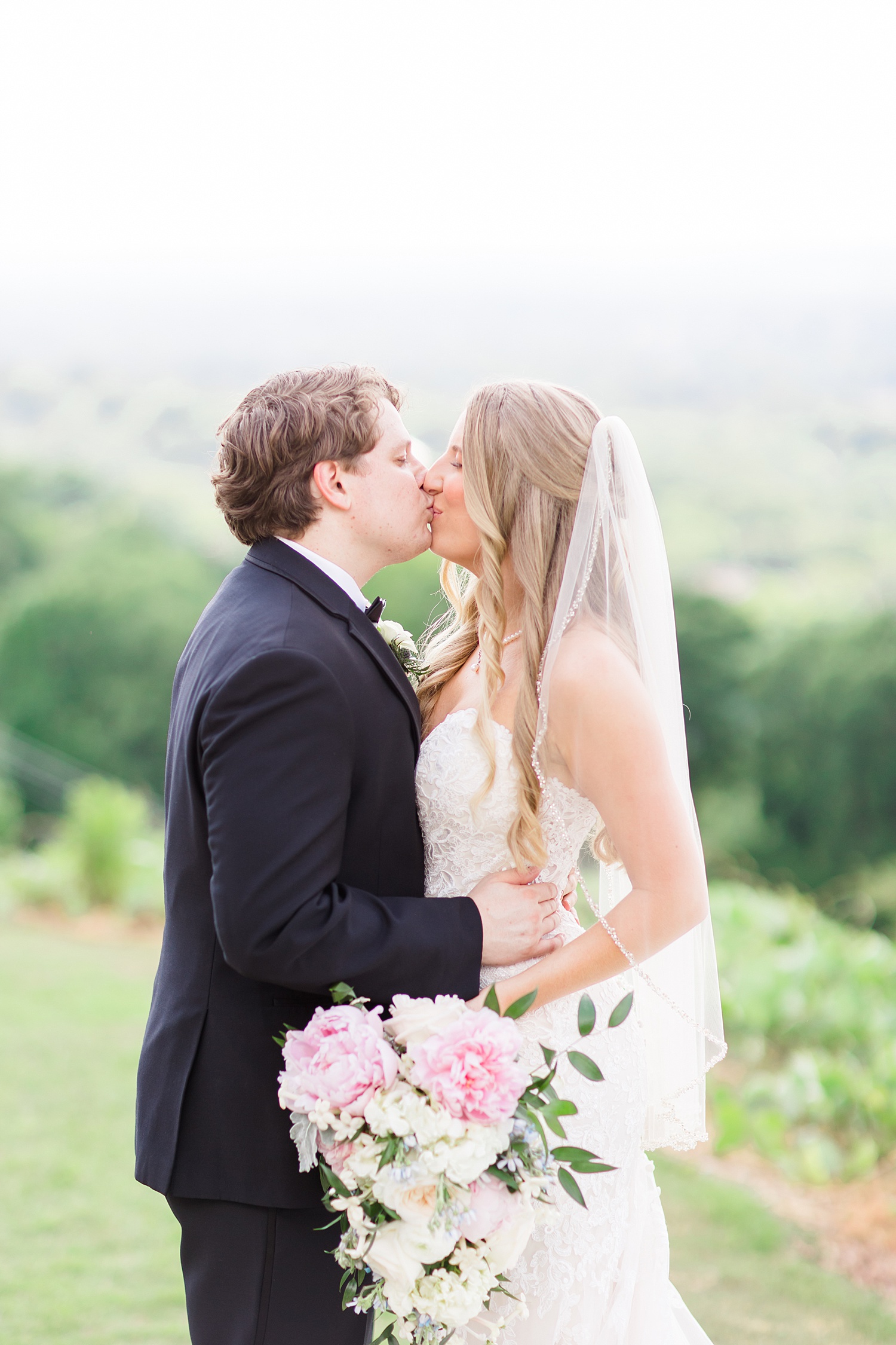 newlyweds kiss after Romantic + Classic  Birmingham Wedding 
