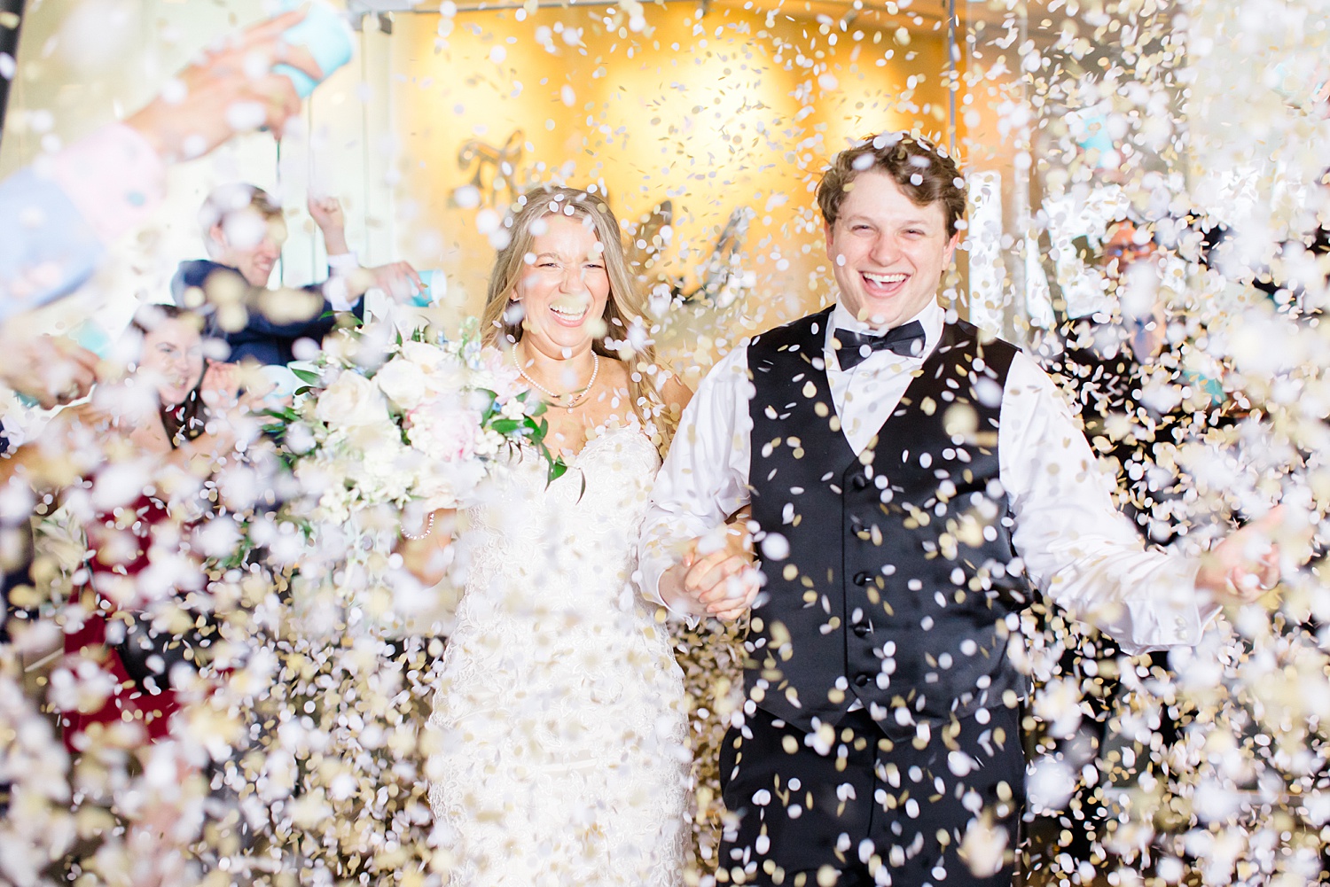 newlyweds exit reception as guests throw confetti 