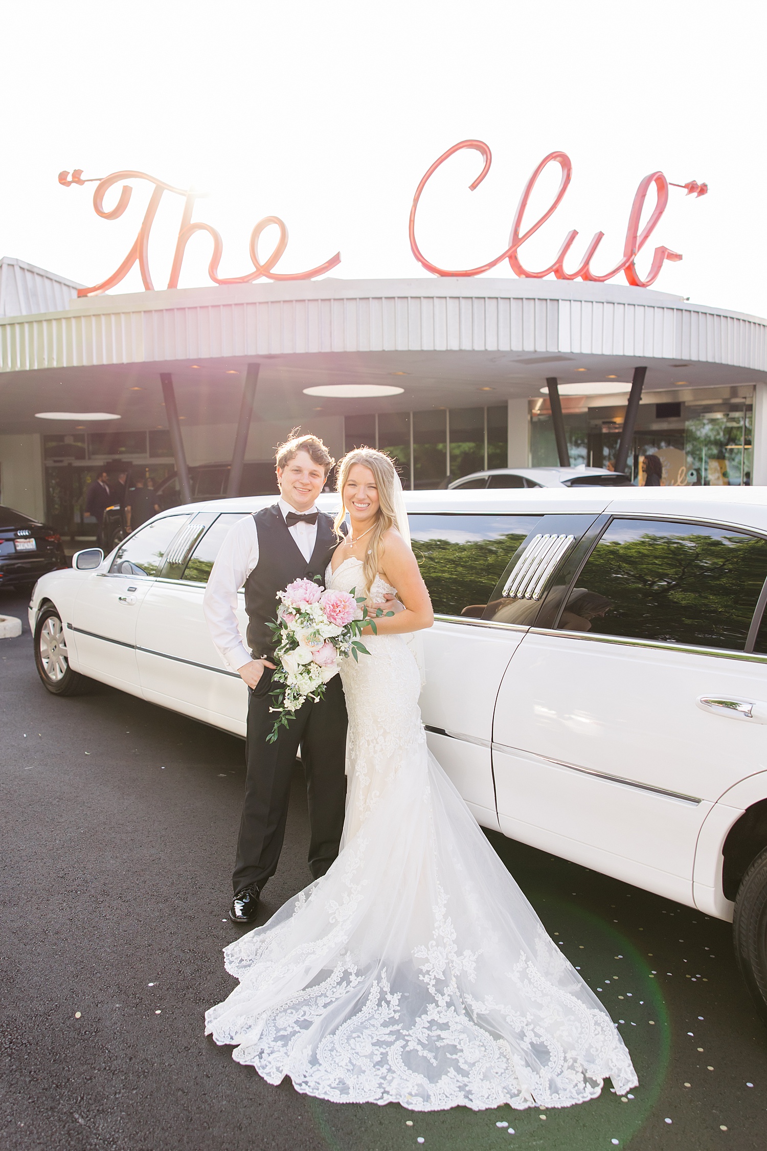 Bride and groom by limo outside of Birmingham Wedding venue The Club