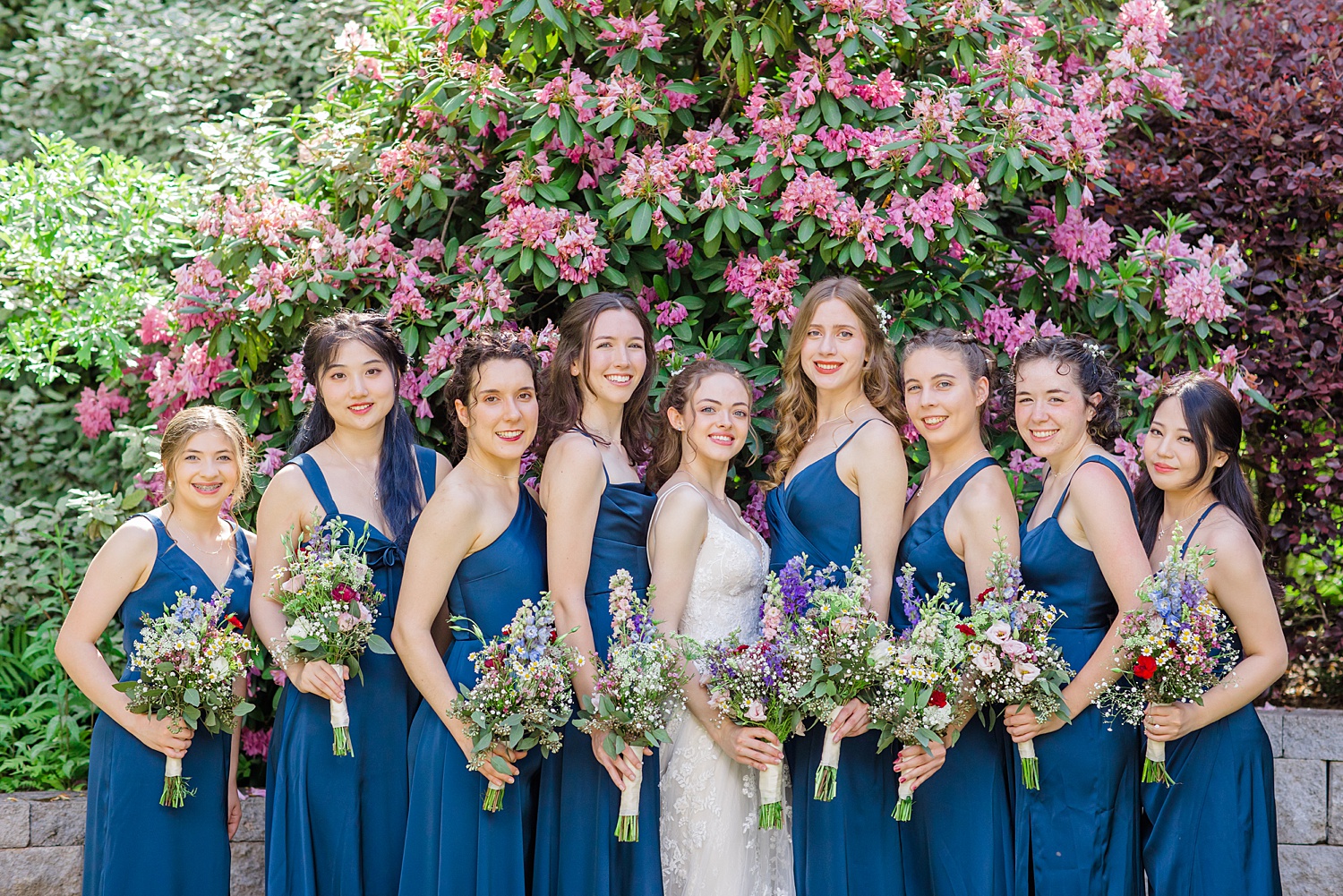 bridesmaids and bride holding their garden inspired wedding bouquets 