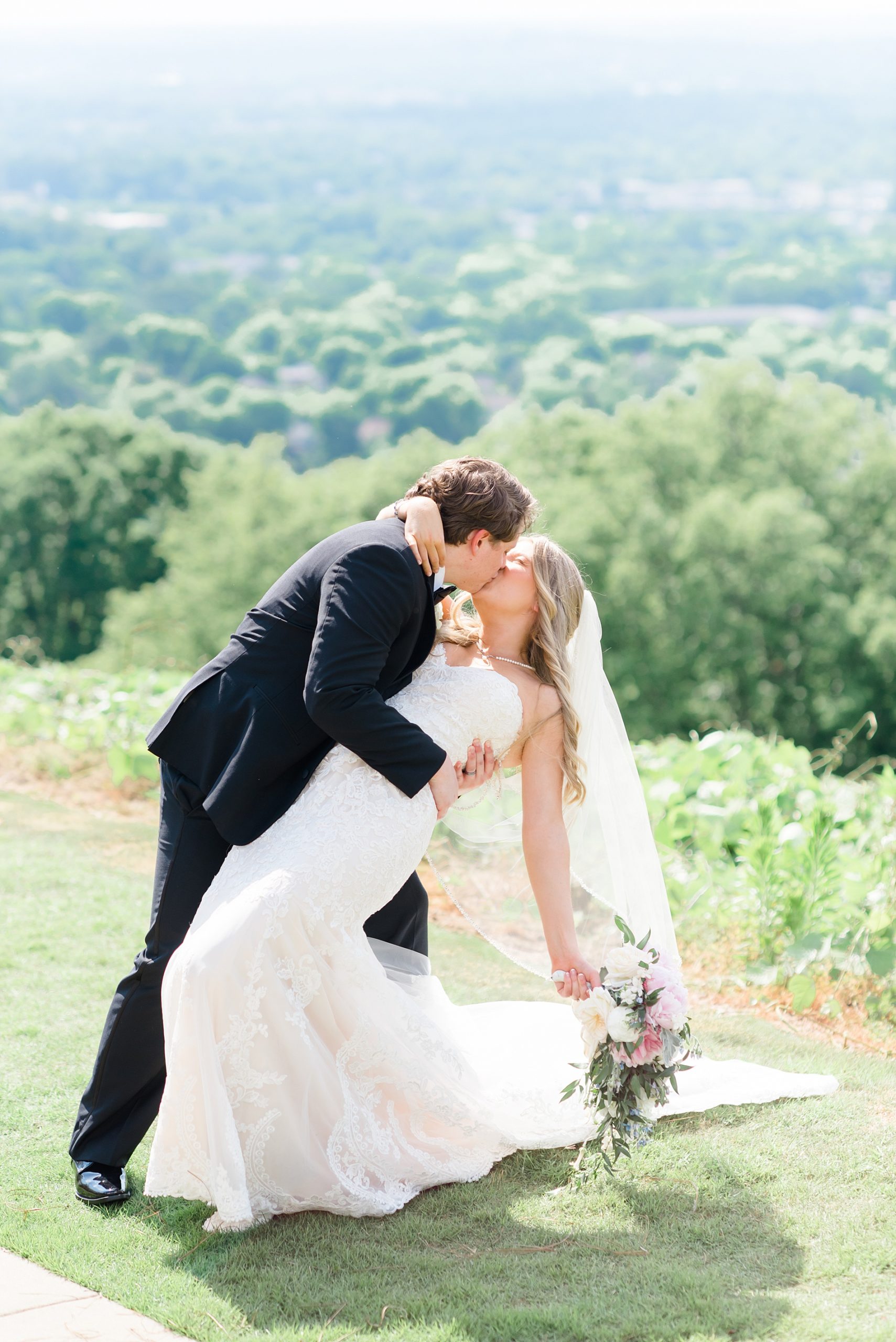husband kisses his bride 