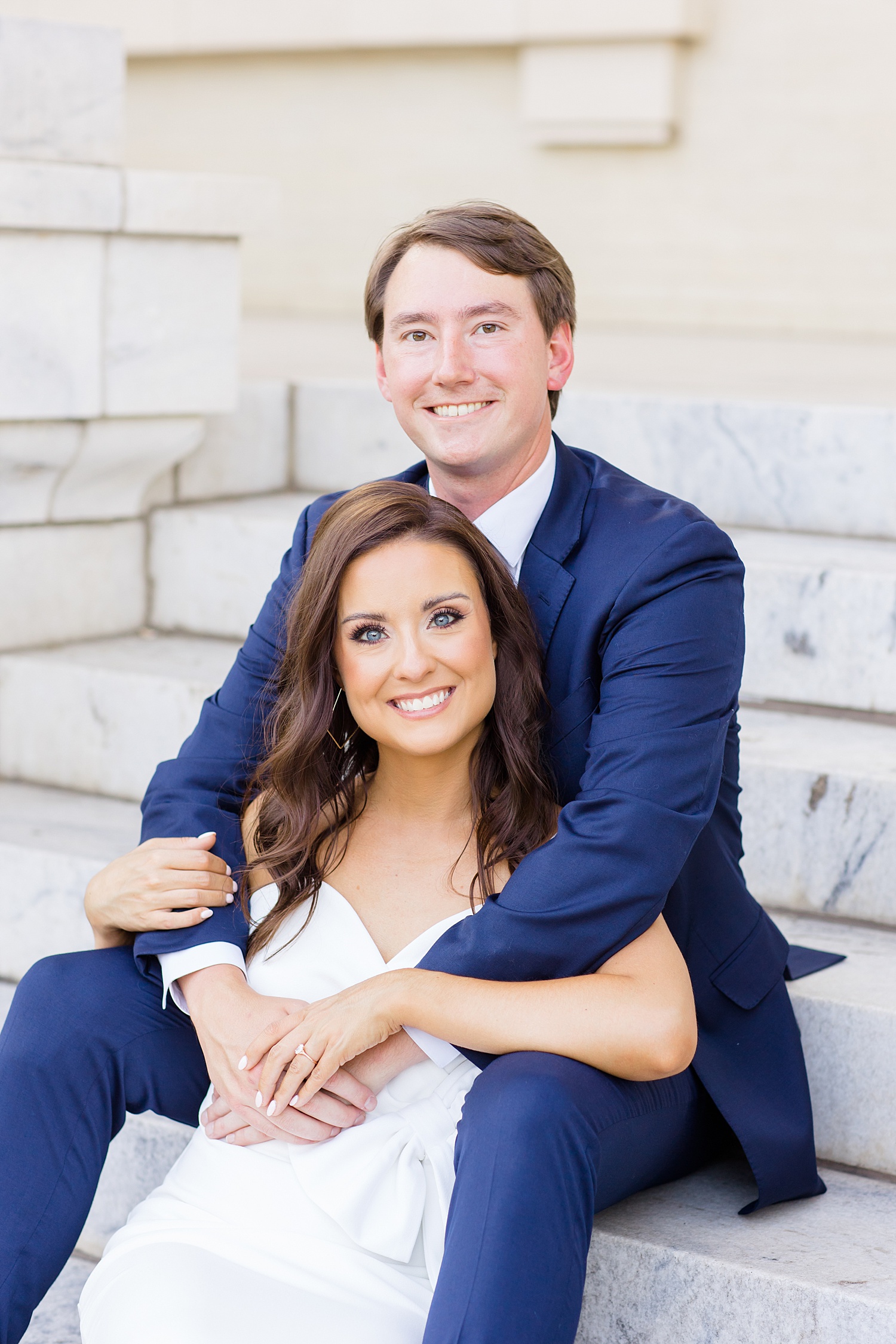 couple sit on the steps of church during Downtown Birmingham Alabama Summer Engagement Session 