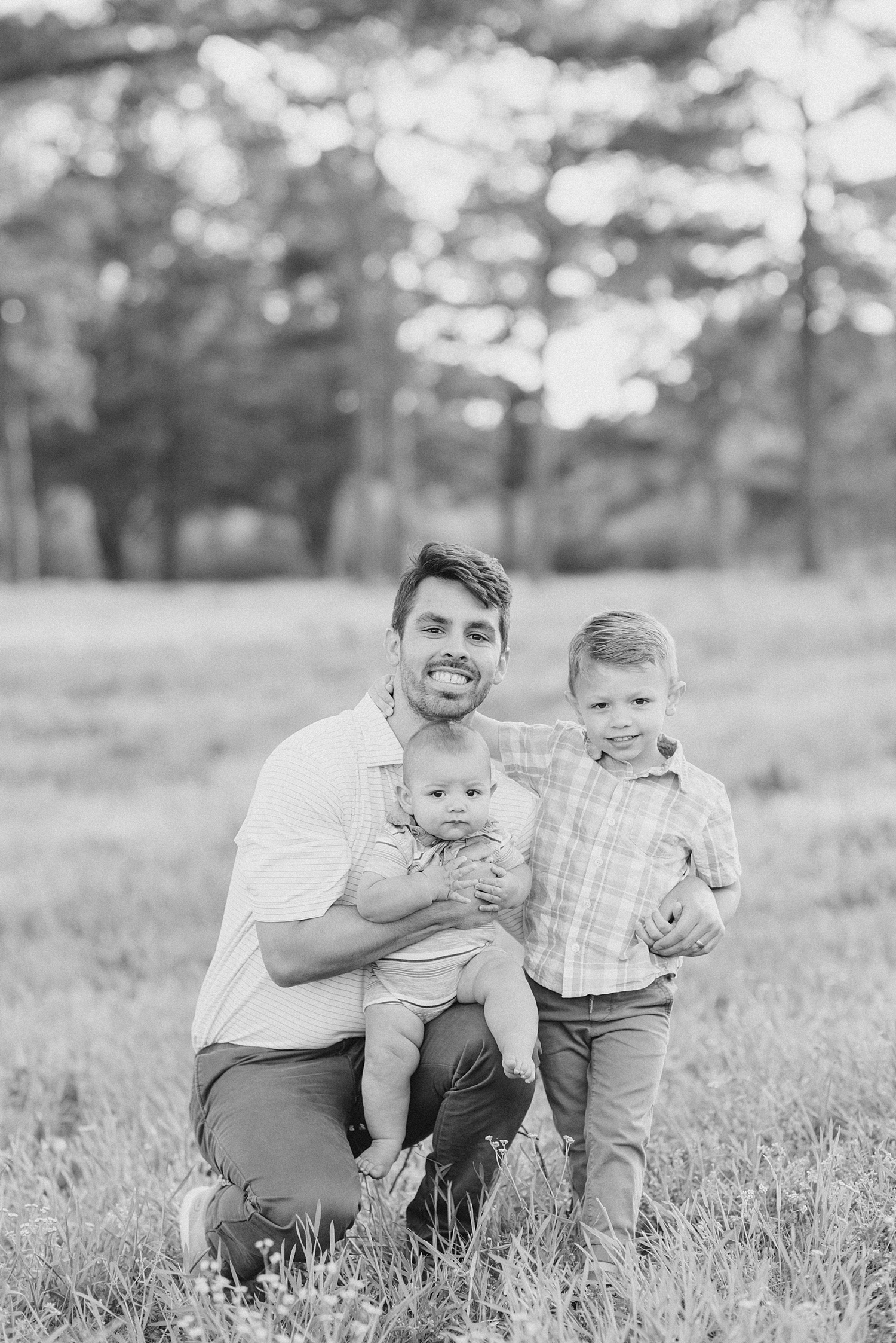 black and white photo of dad with two sons