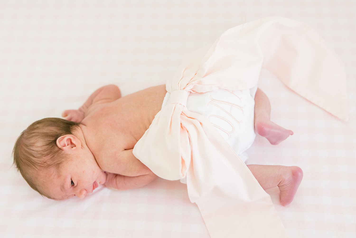 baby girl starts to wake up during newborn session