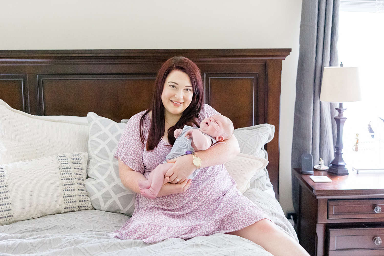 mom holds her newborn son during Birmingham Intimate at-home Newborn + Family Session 