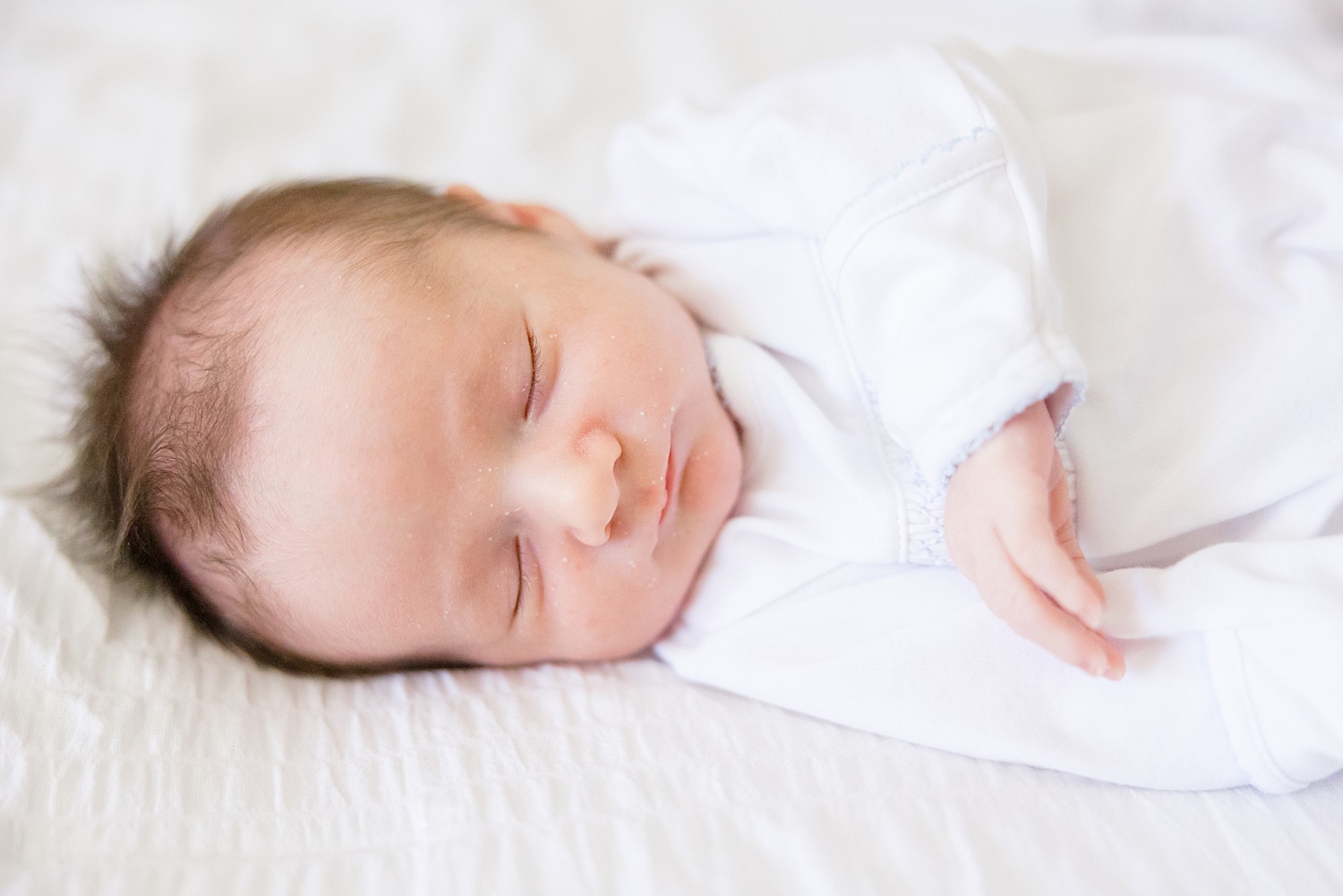 newborn baby boy sleeps during newborn portraits