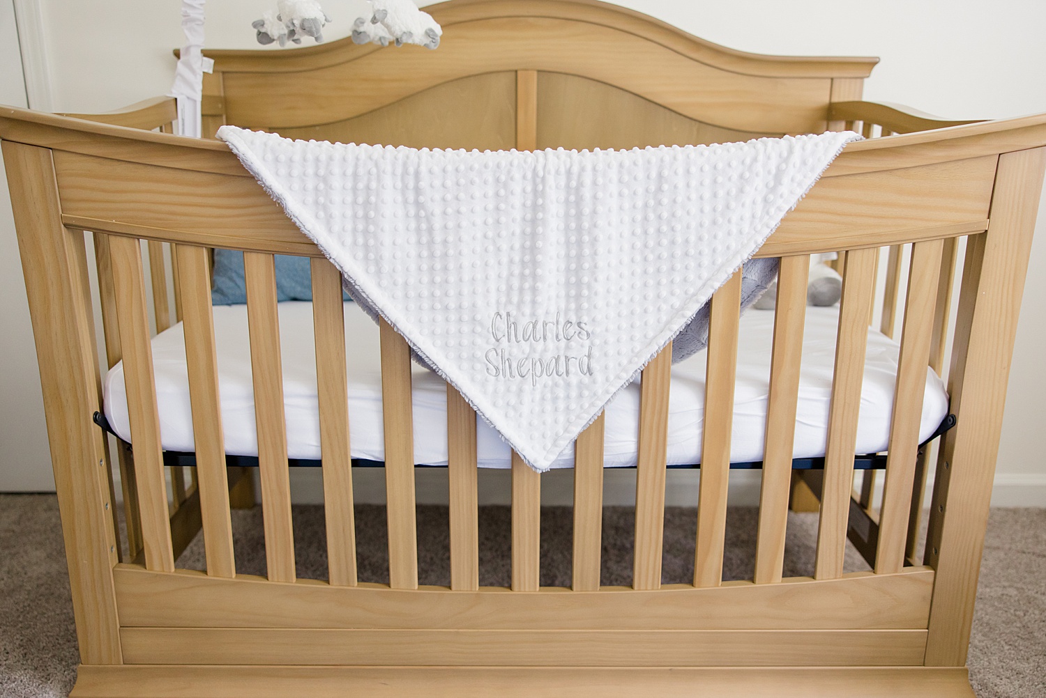 crib with blanket hanging over it