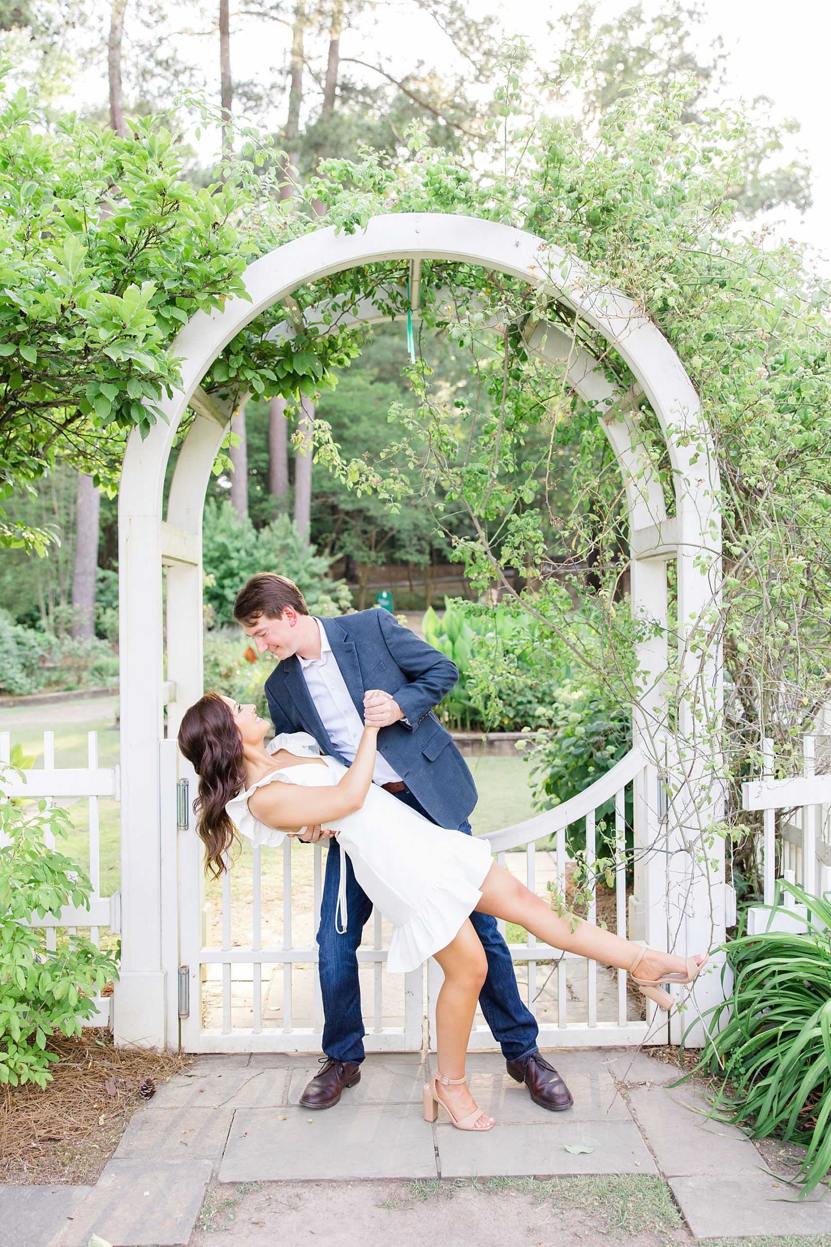 couple dance in the garden during engagement session
