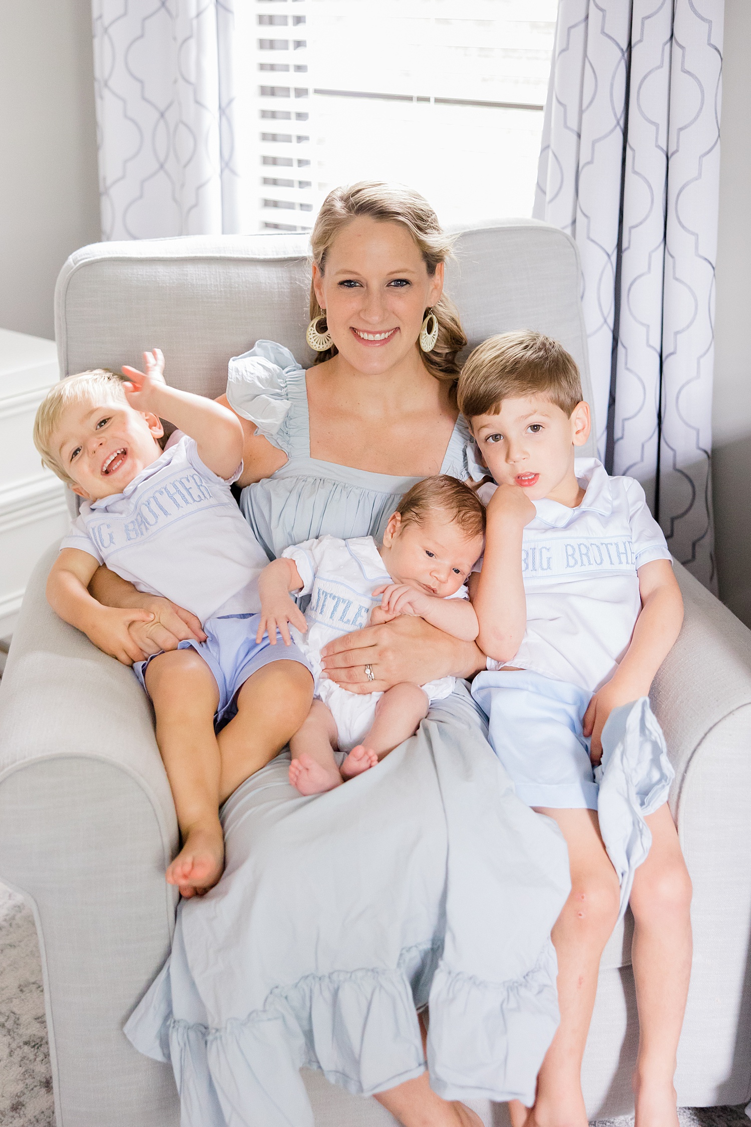 mom holds her three sons on her lap in home during Newborn and Family Milestone Portraits