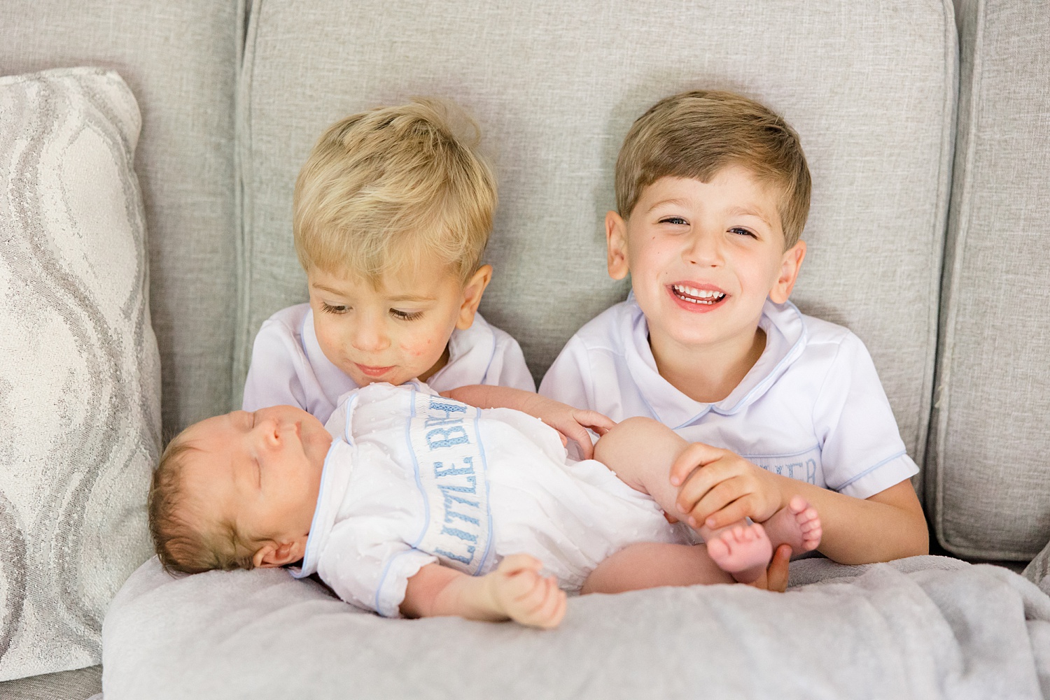 two big brothers admire their new little brother