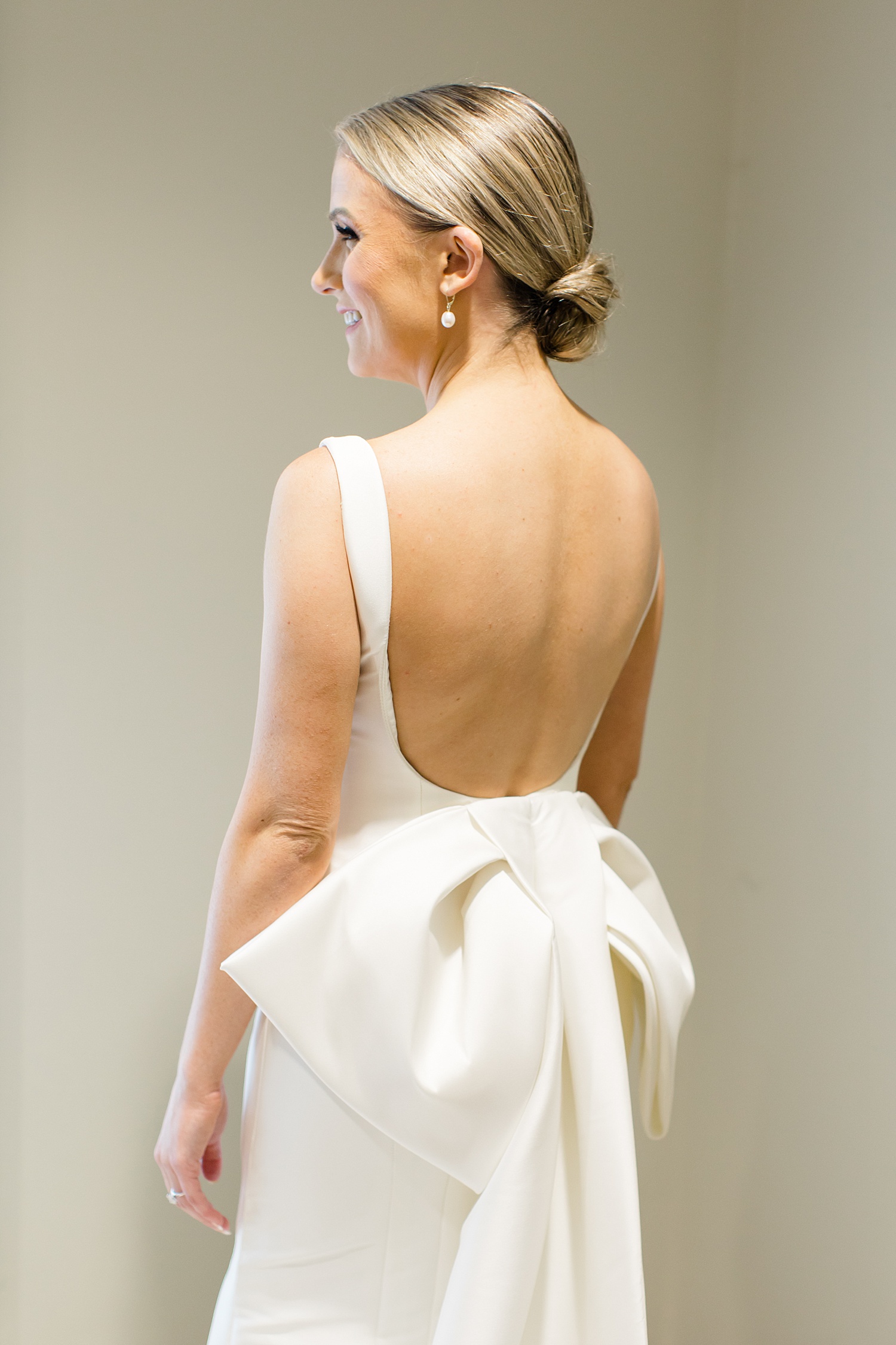wedding gown features large bow