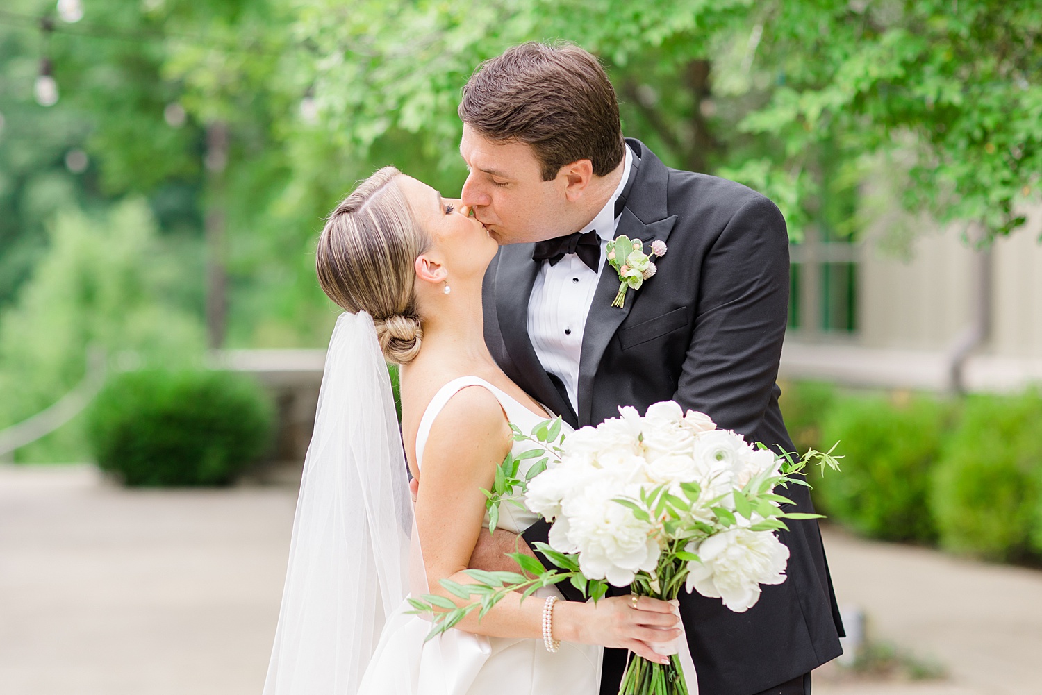 couple kiss during wedding portraits