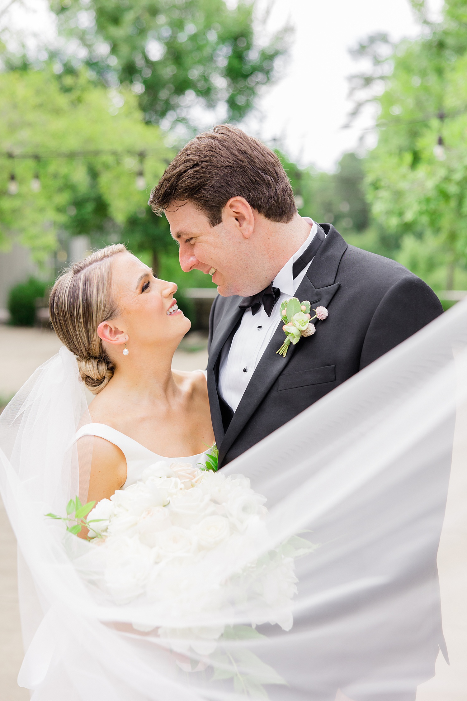 bride's veil wraps around newlyweds 