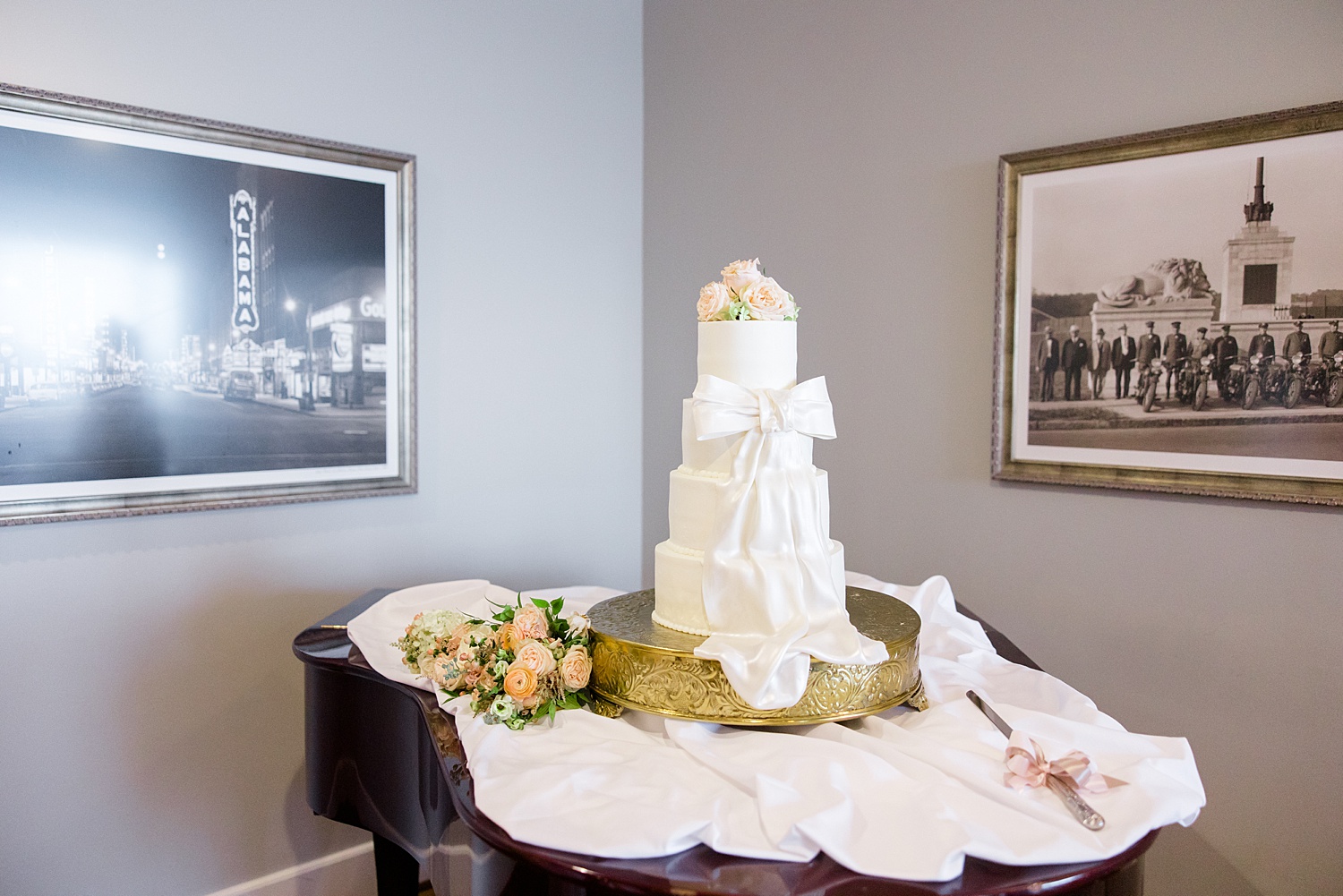 4 tier white wedding cake with bow on front