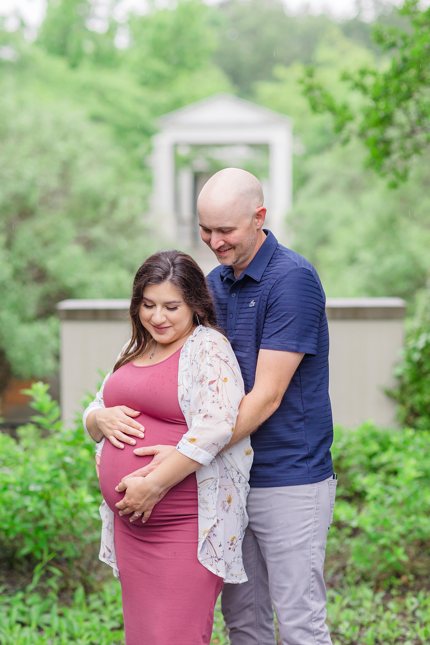 couple put hands on baby bump during Birmingham Engagement + Maternity session