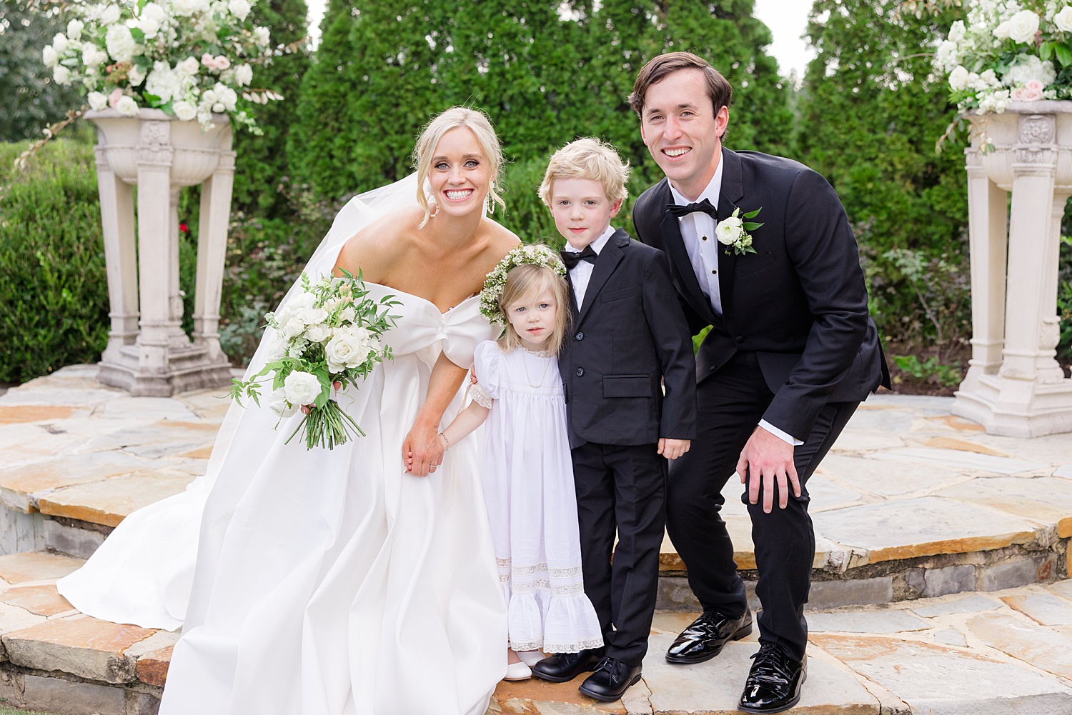 bride and groom with ring bearer and flower girl