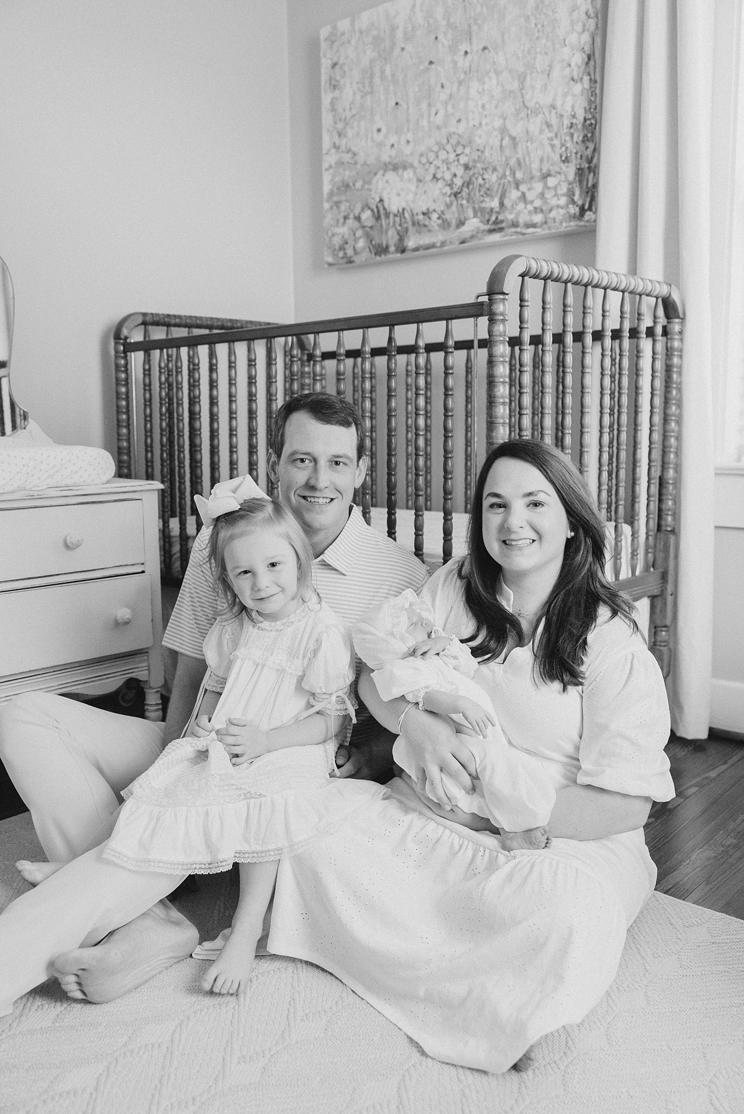 family portraits in baby girl's nursery in family home