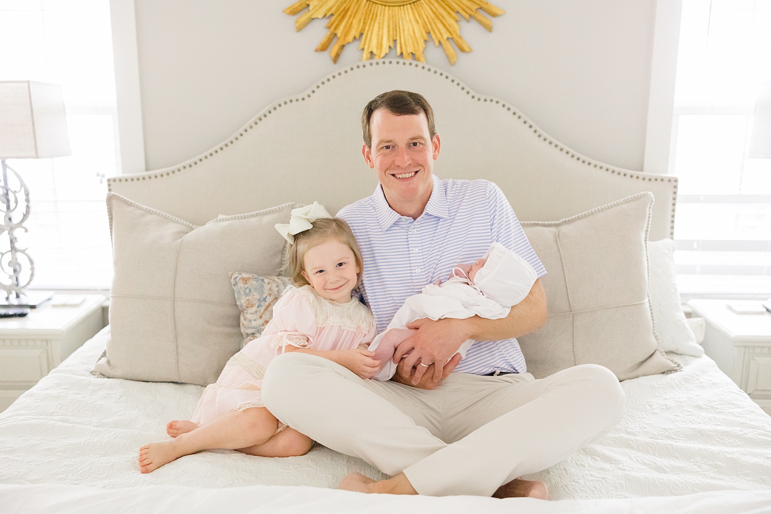 dad with his two daughters during In-Home Newborn Lifestyle Portraits in Trussville, AL 