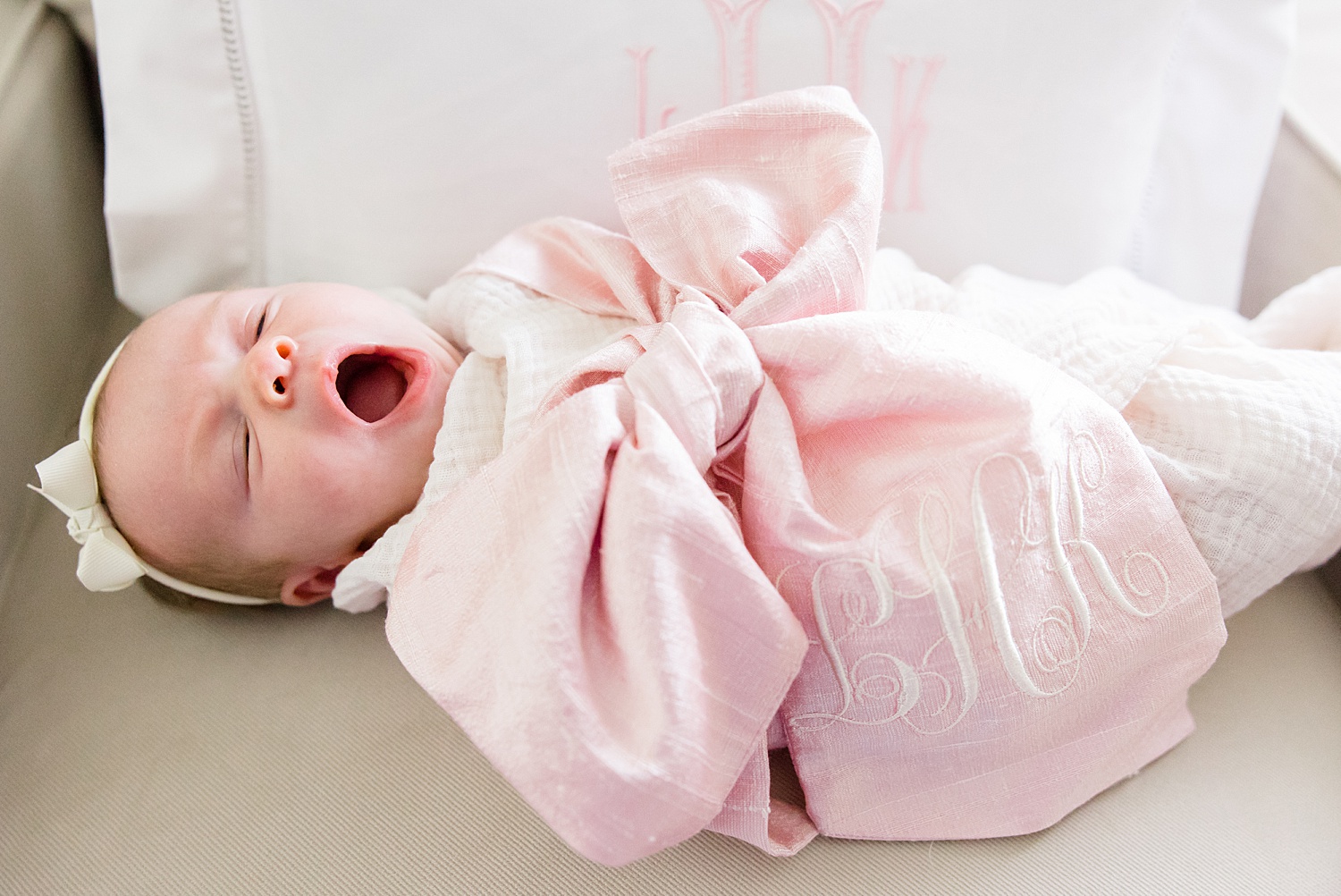 newborn girl gives a big yawn during In-Home Newborn Lifestyle Portraits 