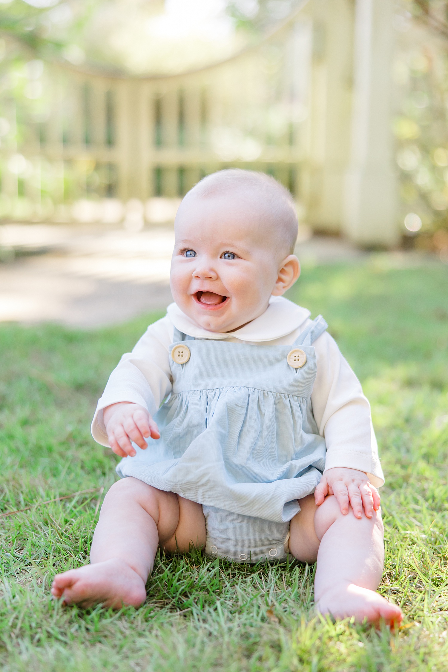 baby boy smiles during milestone portraits