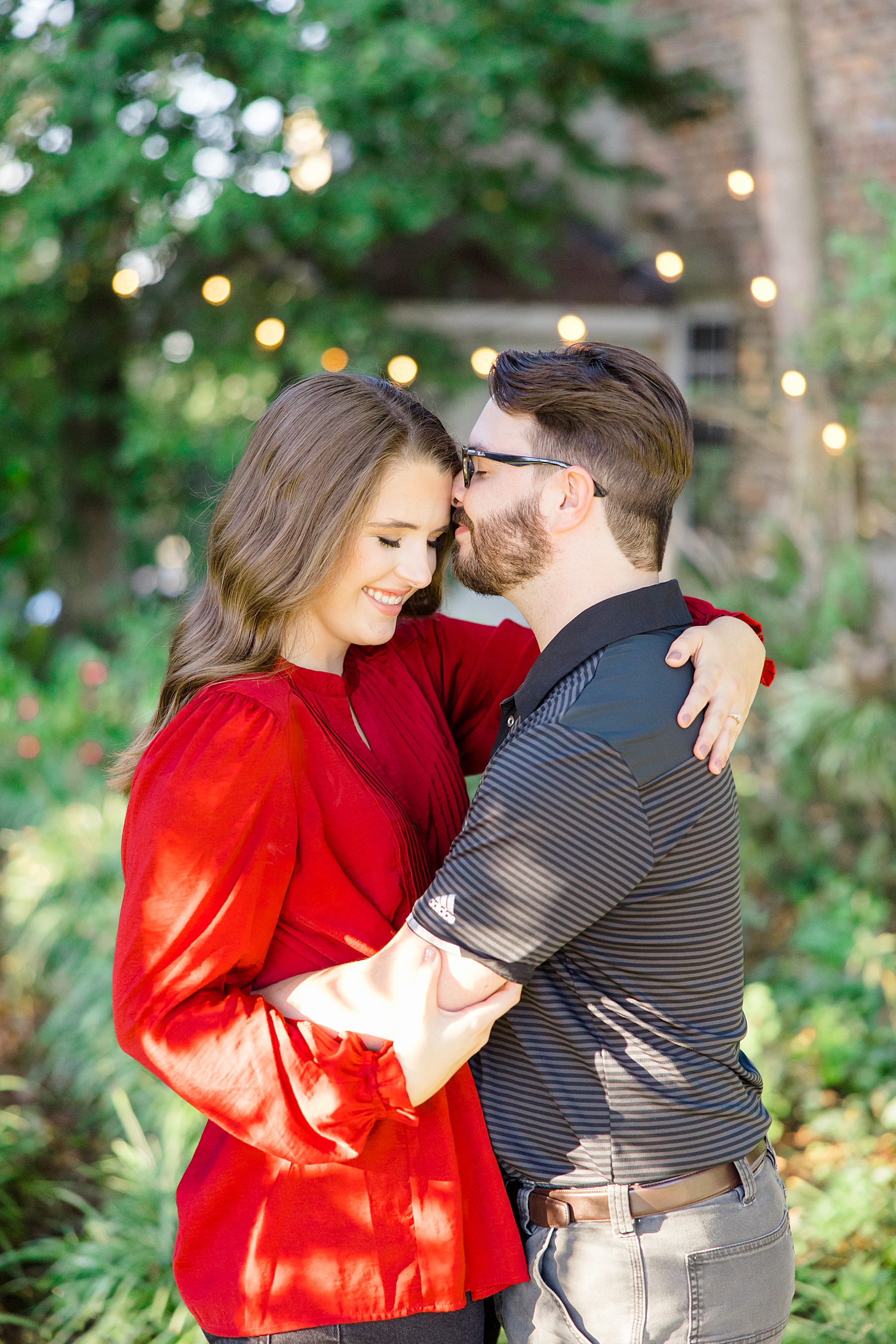 candid engagement portraits with twinkling lights