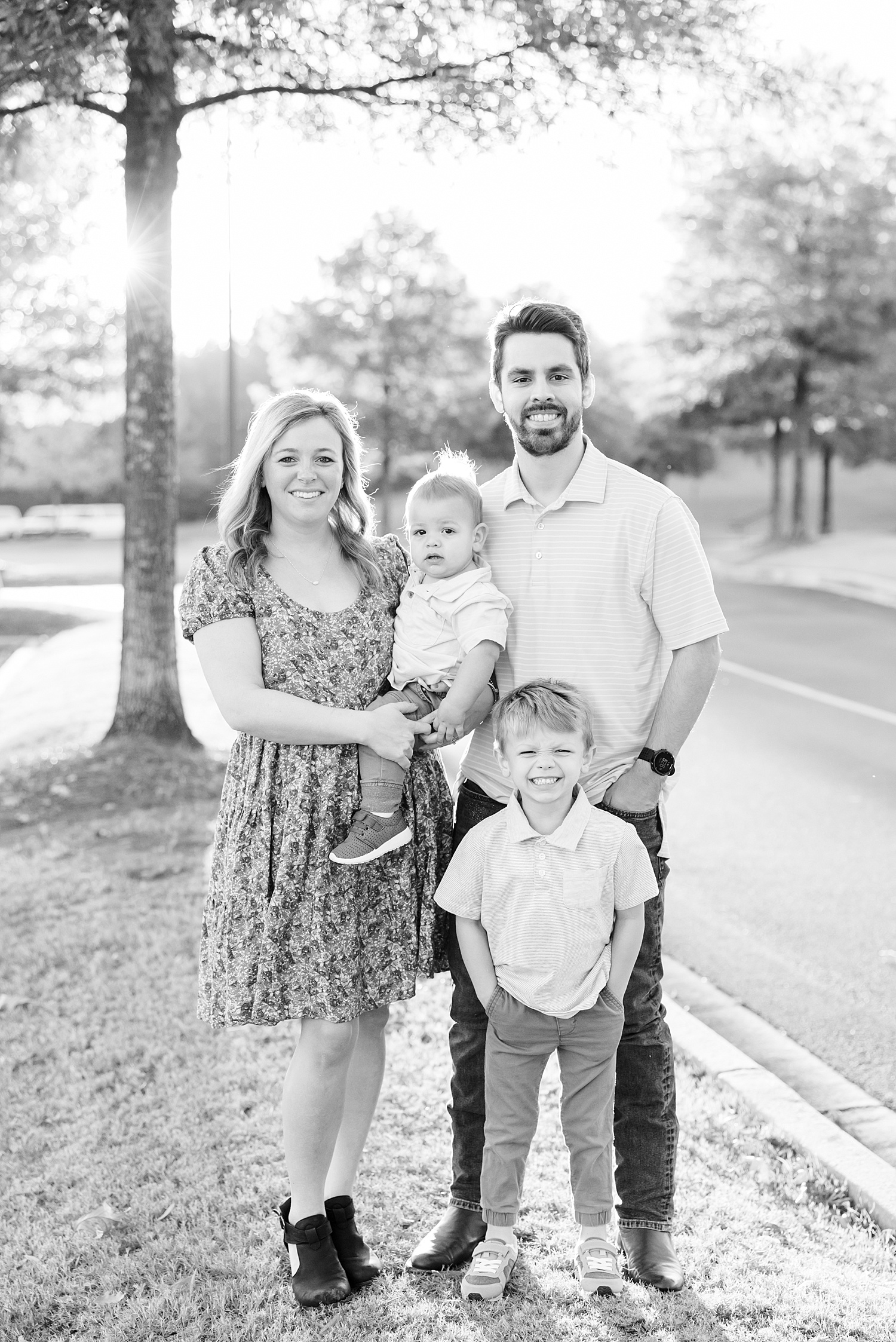 family stands by road in Birmingham during family session