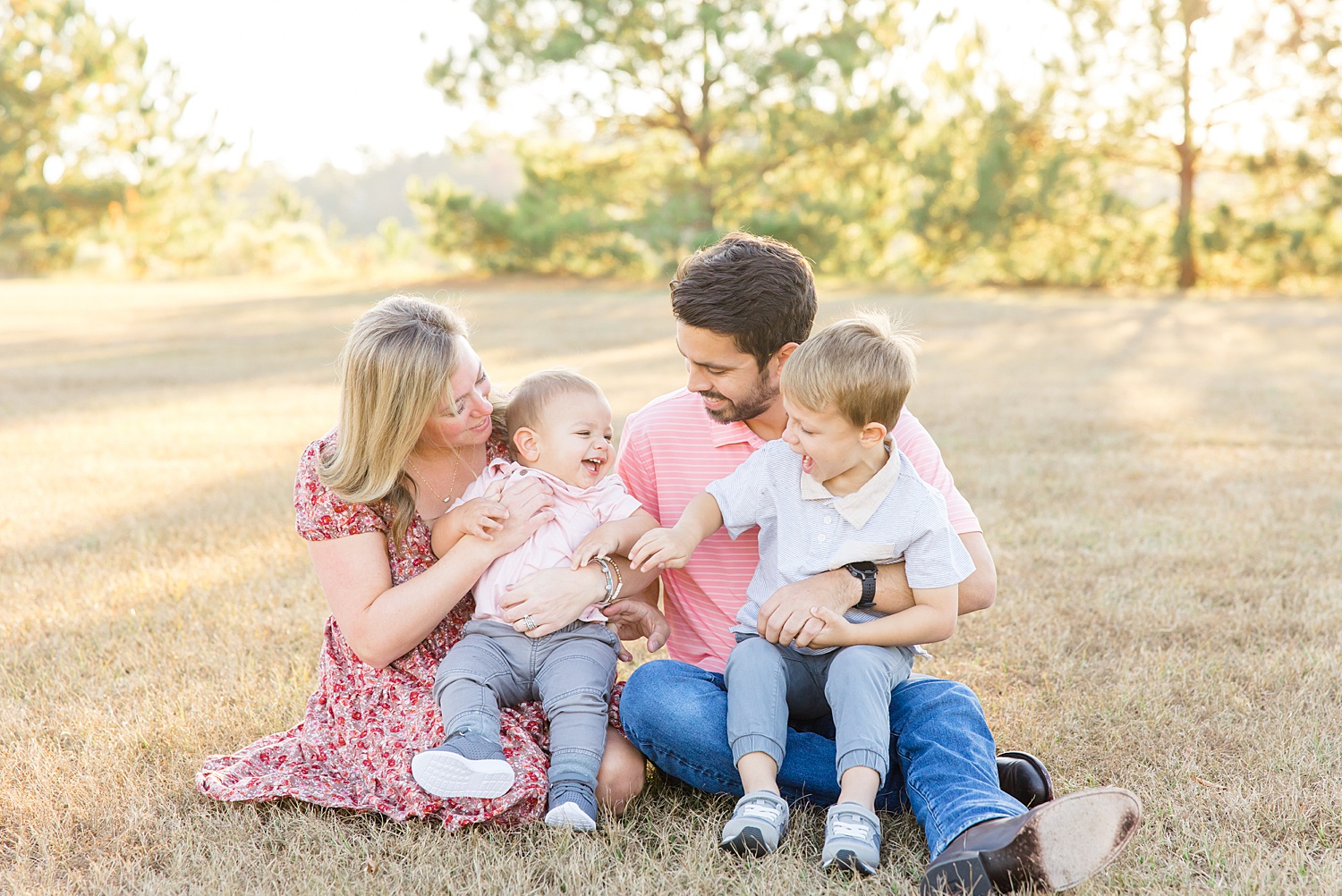 family sits in grass for Birmingham Fall Family Session