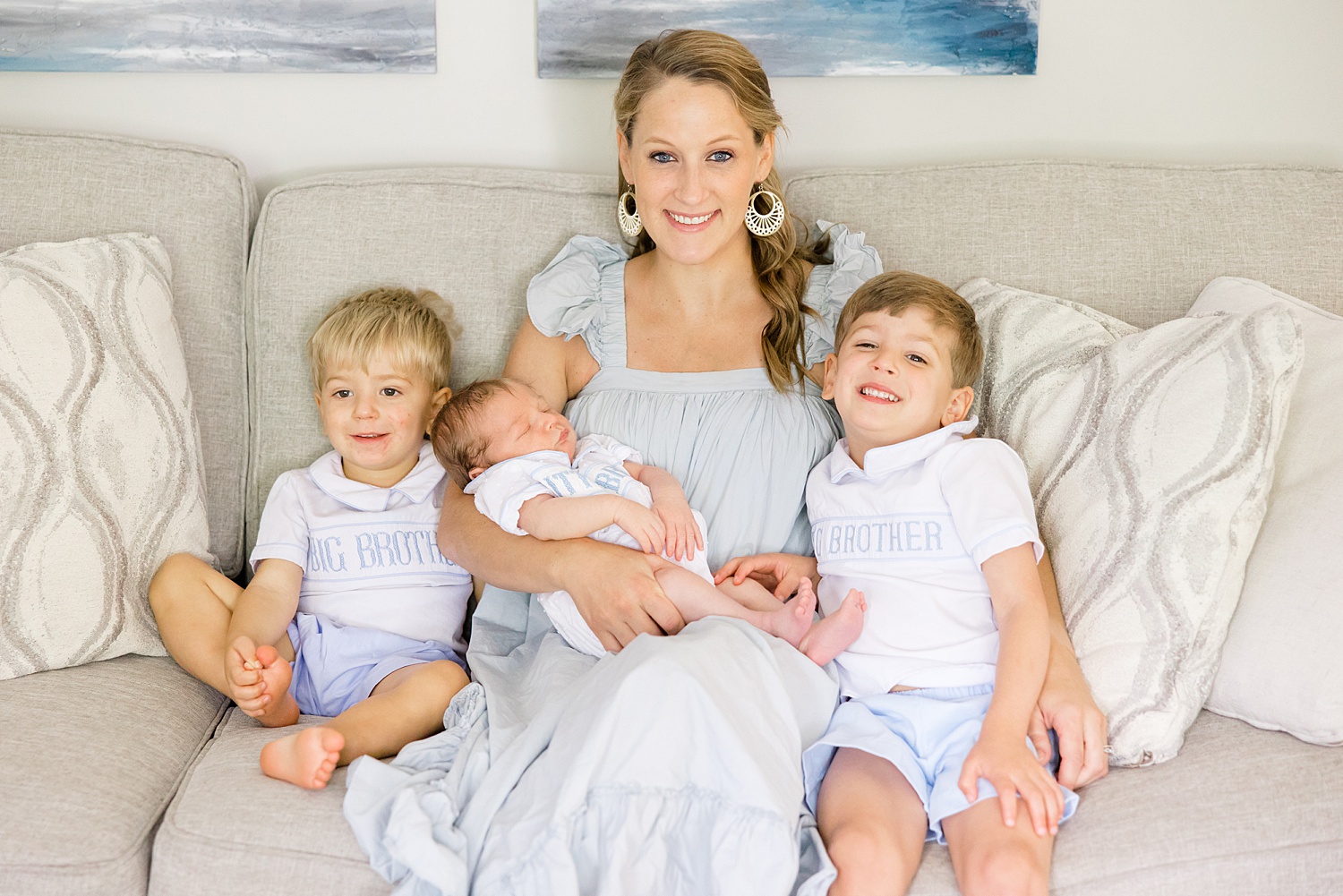 mom sits with three boys during in-home newborn session