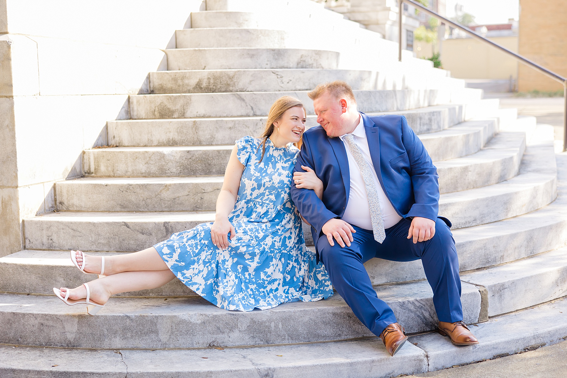 engaged couple sit on stairs in downtown Birmingham AL