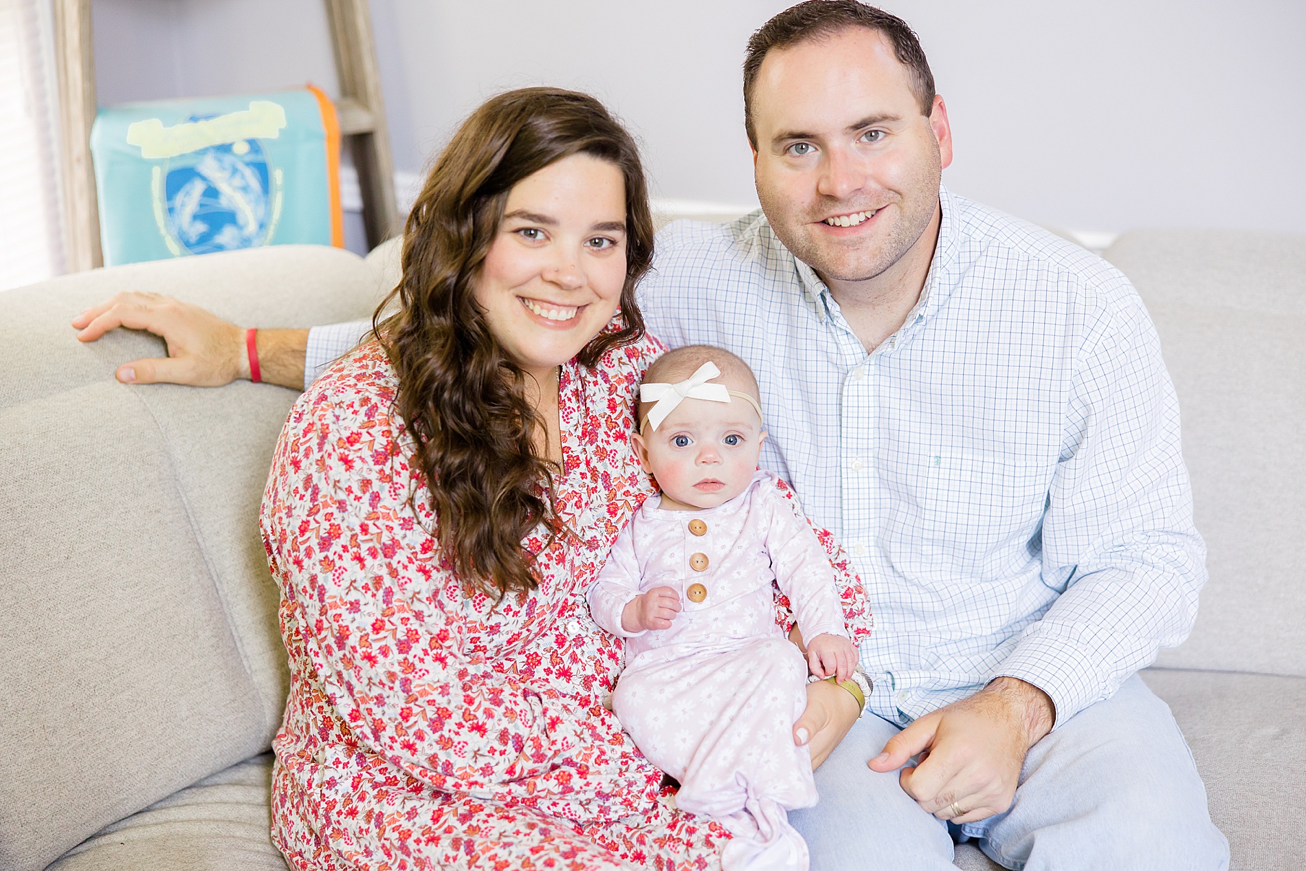 parents hold newborn girl