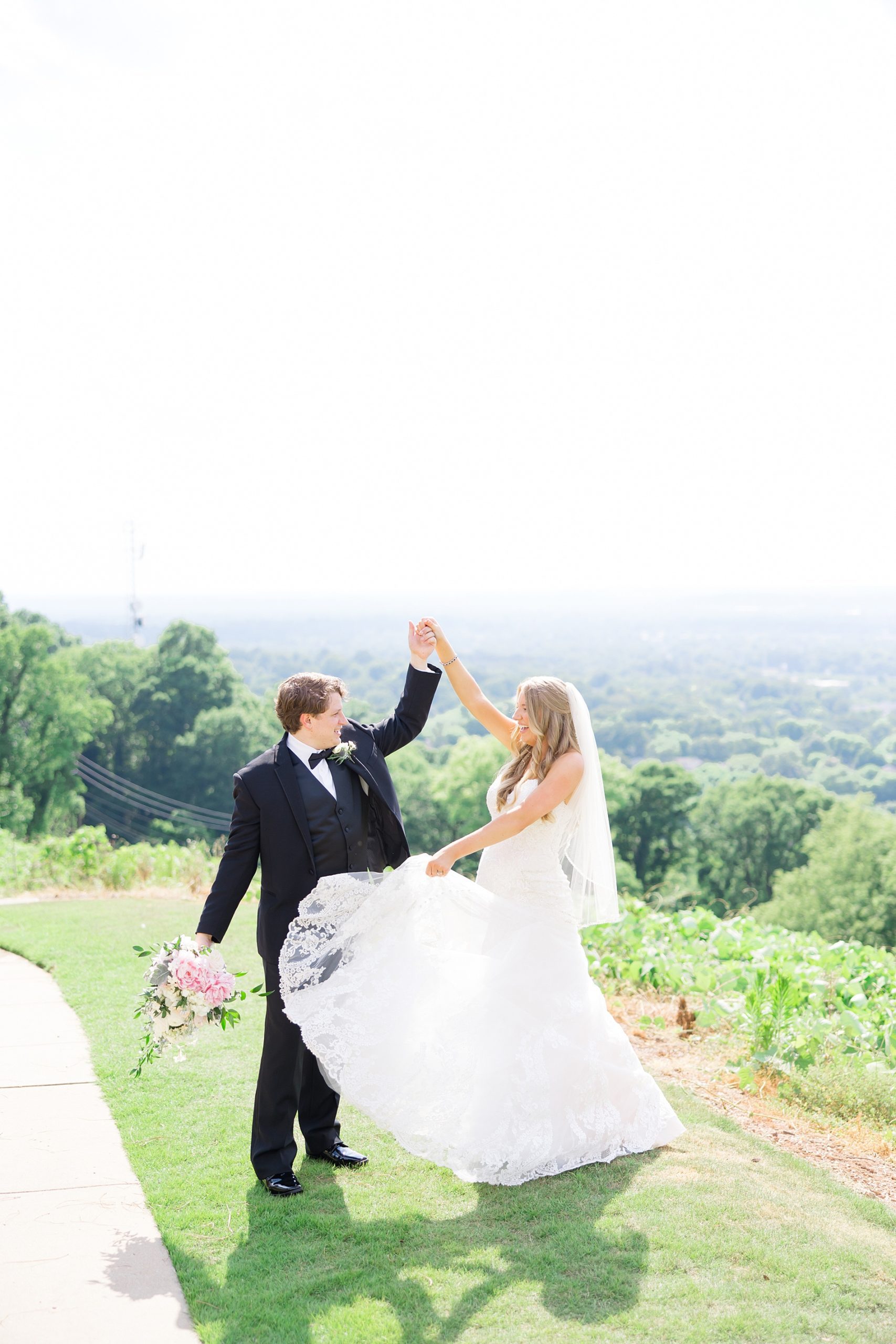 bride and groom dance on hillside during Birmingham wedding