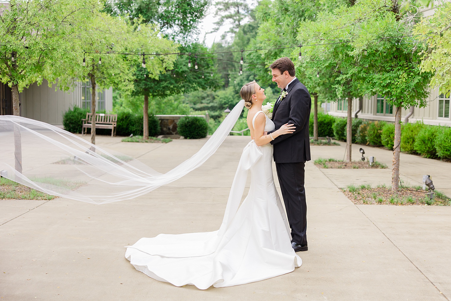 classic wedding portraits of 2022 with bride's veil trailing behind