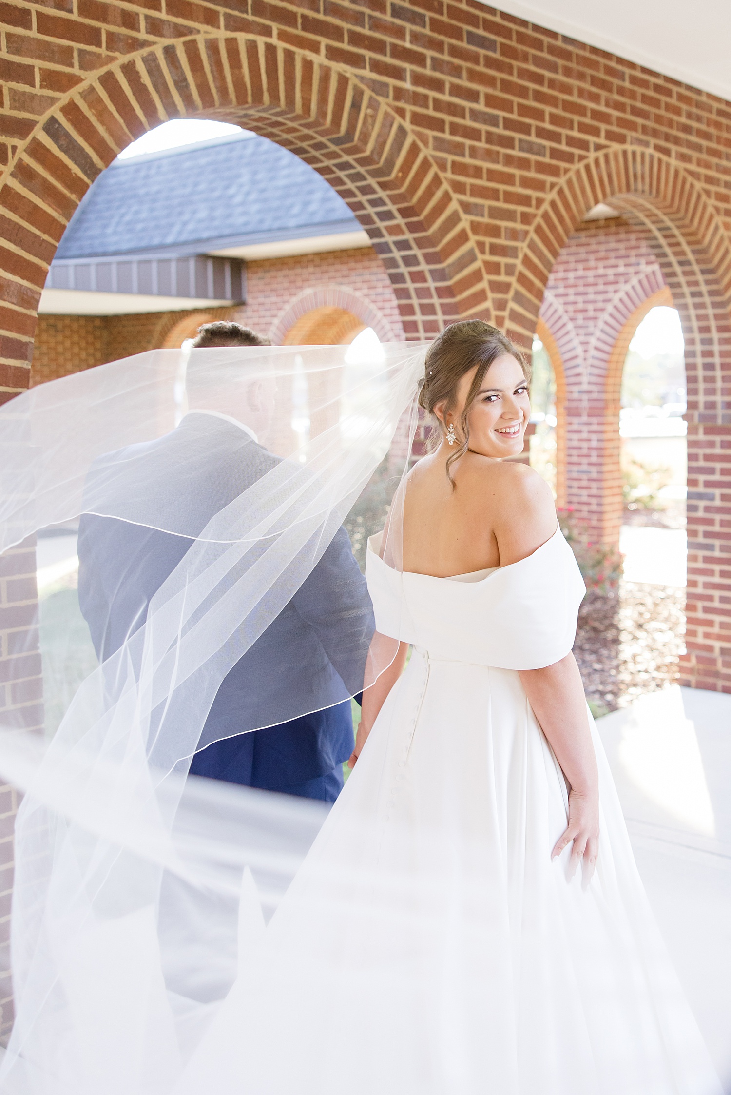 bride walks with veil fluttering behind her | Birmingham weddings of 2022