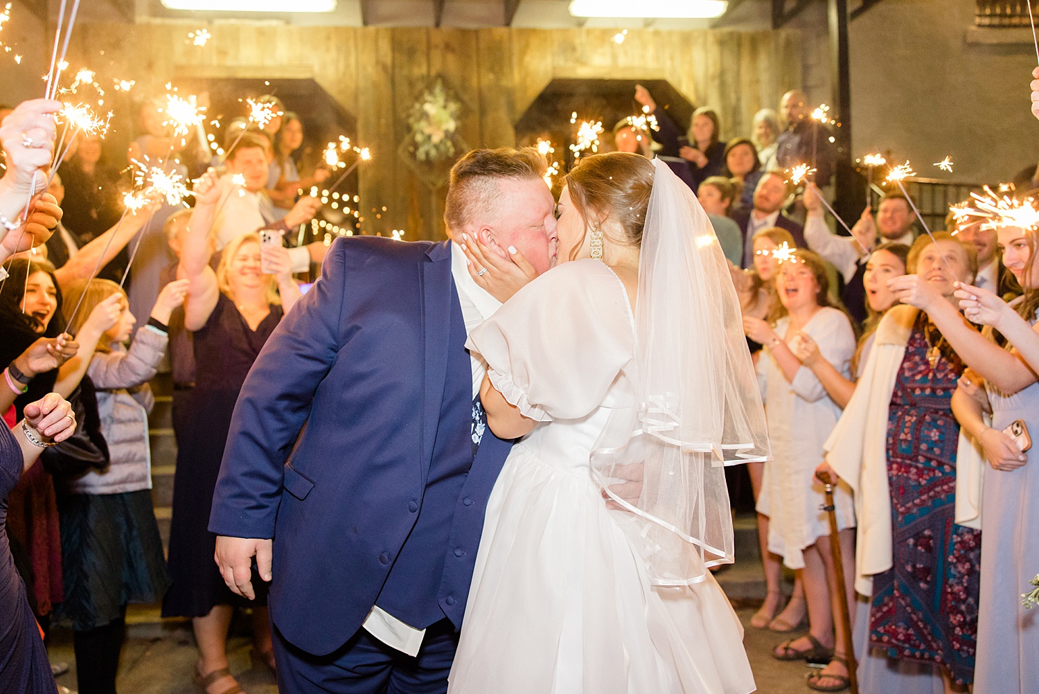 newlyweds kiss during sparkler exit