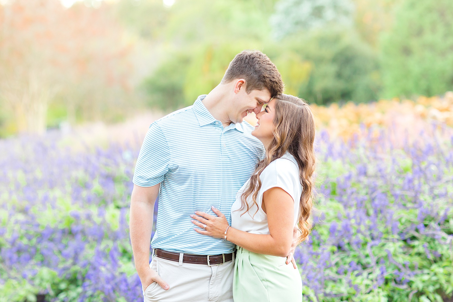 couple engagement portraits in field of purple flowers