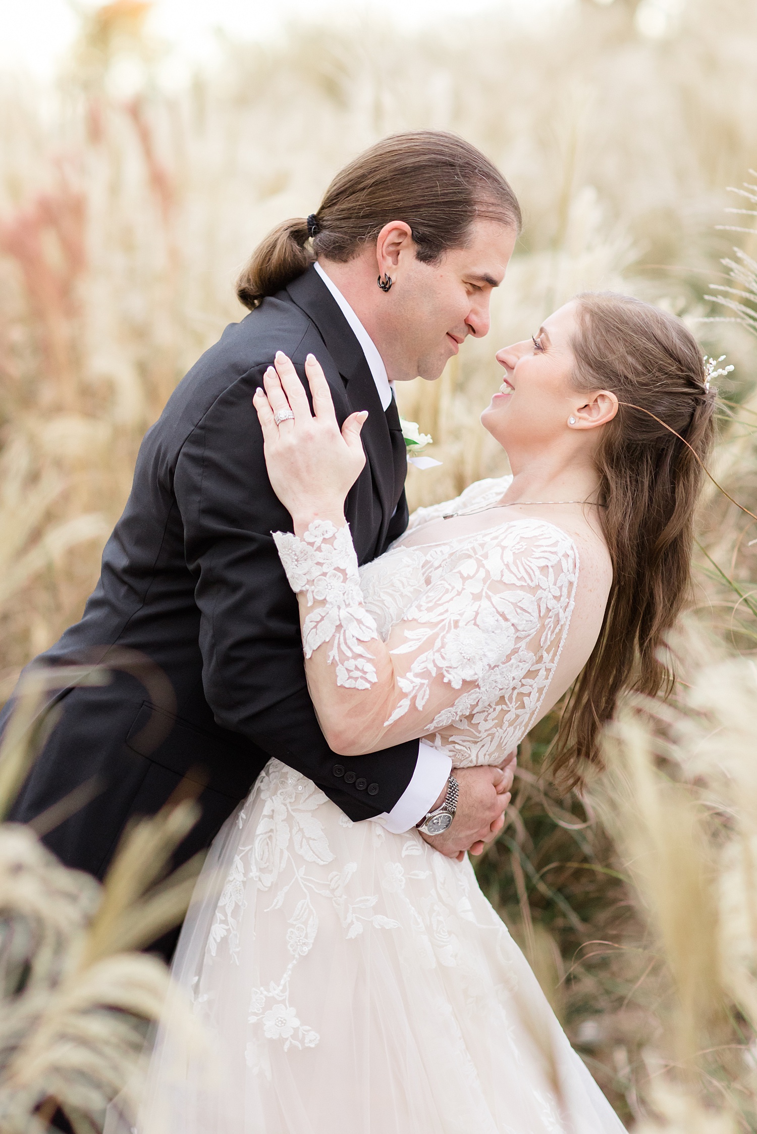 newlyweds in field of tall grass 